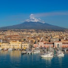 Port of Catania, Sicily. Mount Etna in the background., License Type: media, Download Time: 2024-12-30T03:13:08.000Z, User: hannahblackie10, Editorial: false, purchase_order: 56530 - Guidebooks, job: Global Publishing WIP, client: Sicily 11, other: Hannah Blackie