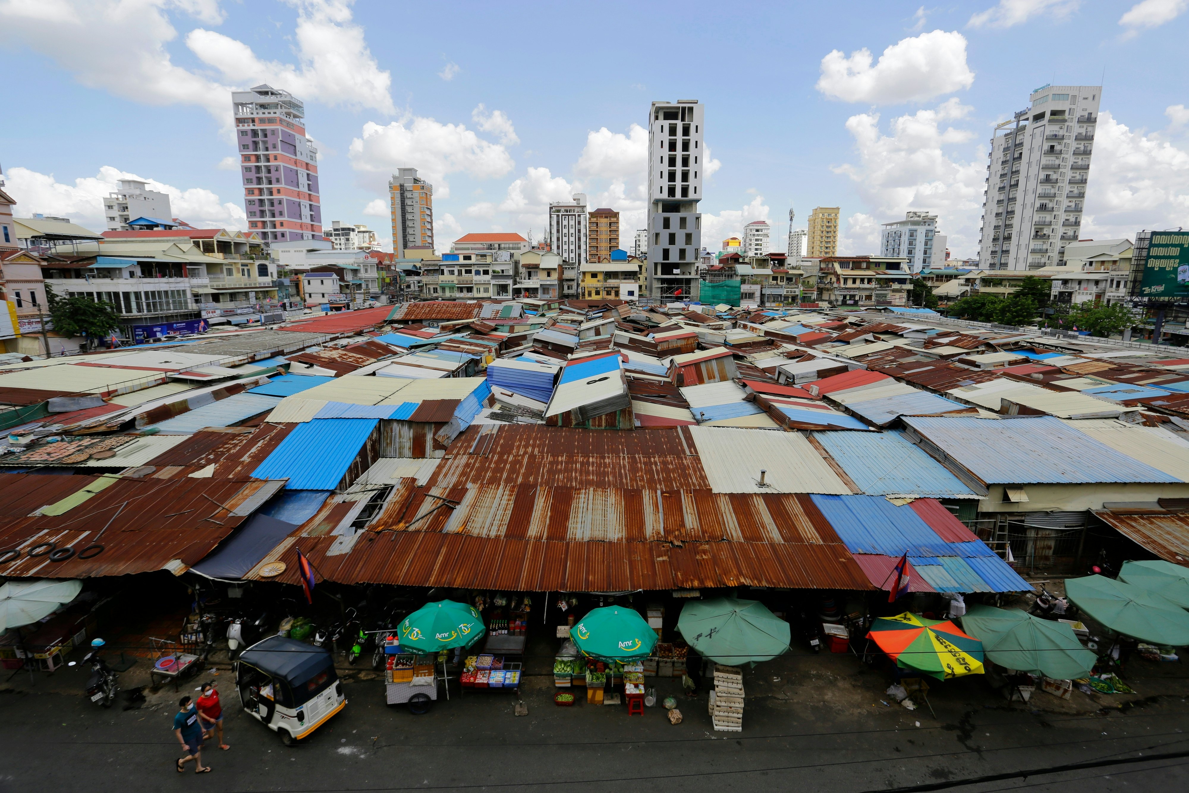 An aerial view of the patchwork roofs of a market in Cambodia.