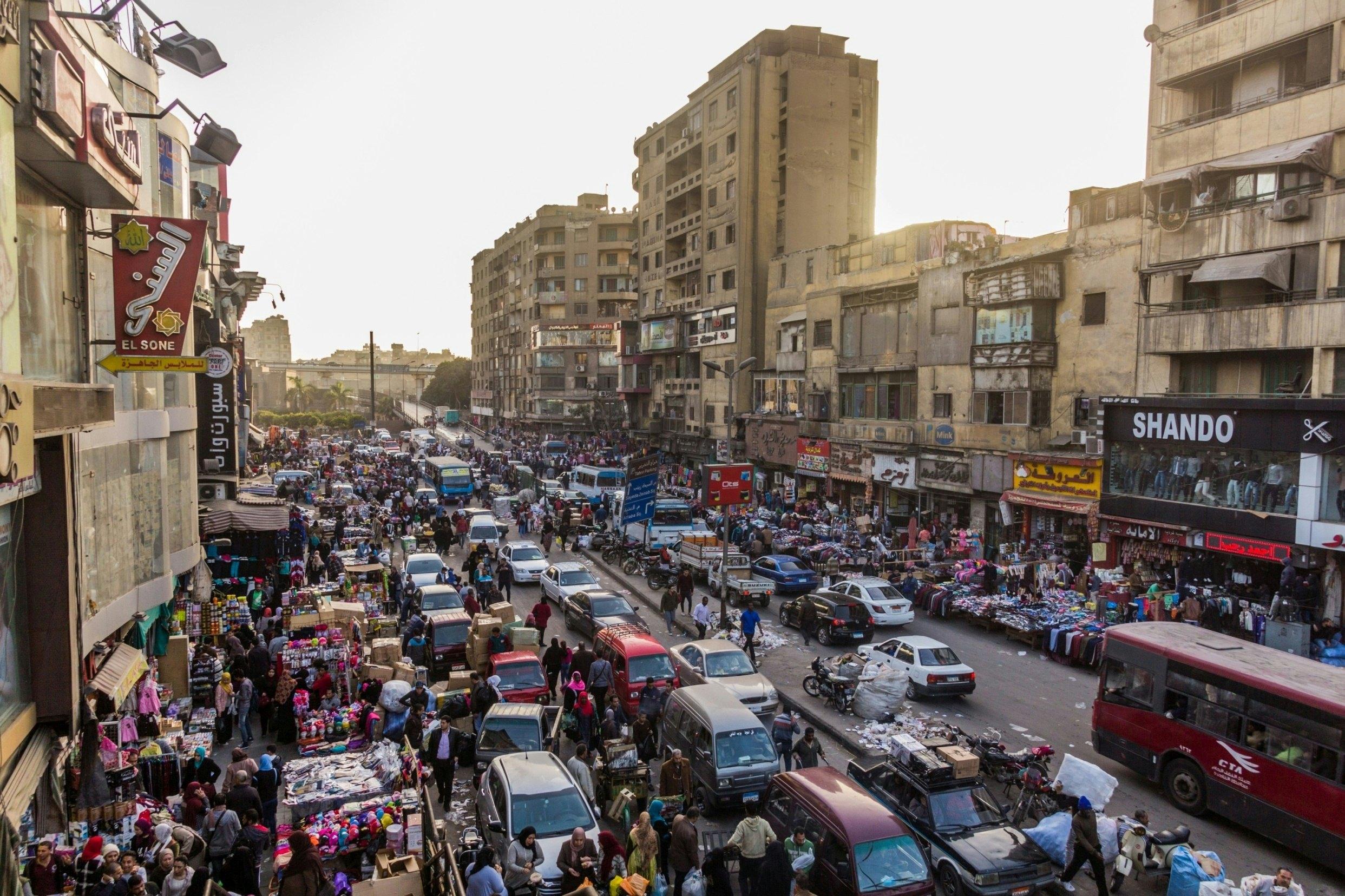 A road packed with vehicles and vendors in Egypt.