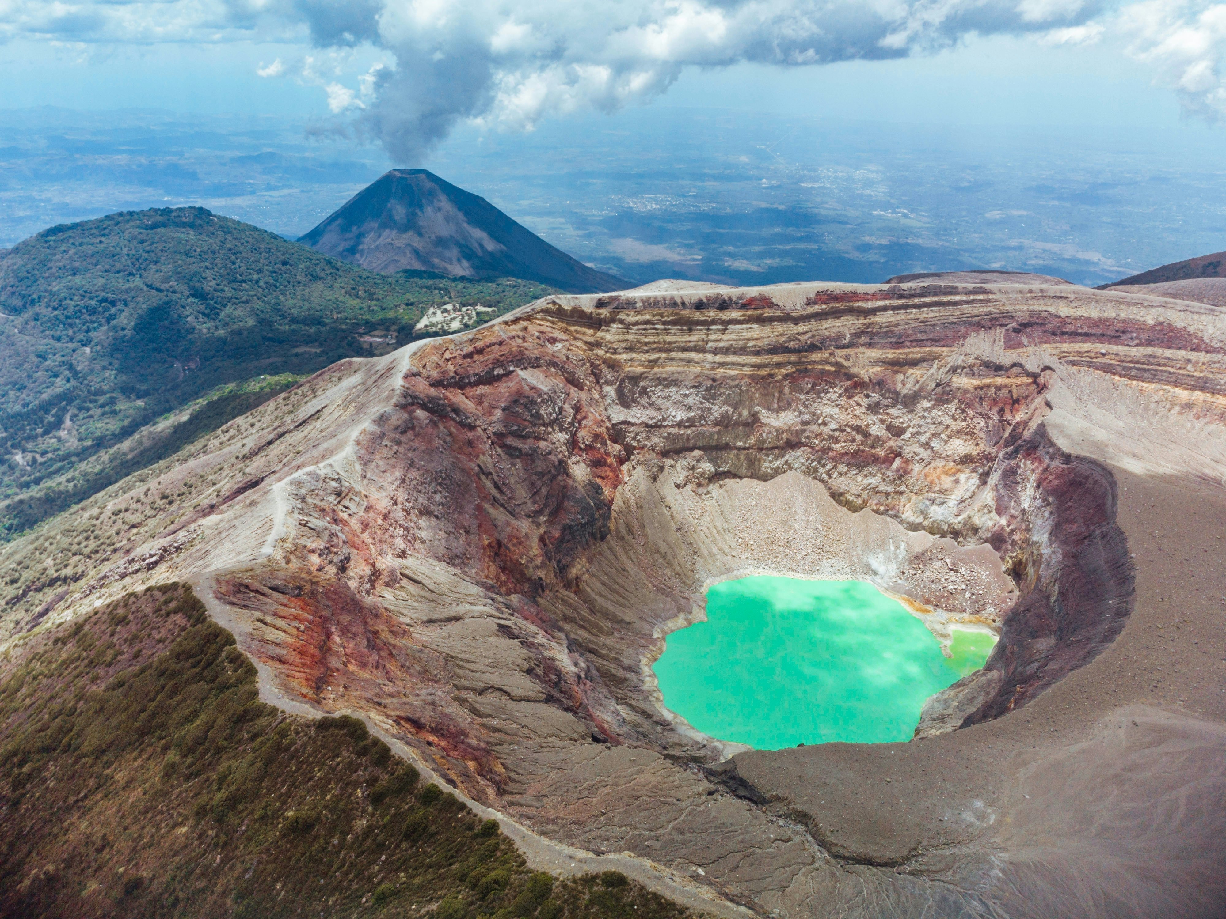 Aerial view of a turquoise lake in a volcano crater
