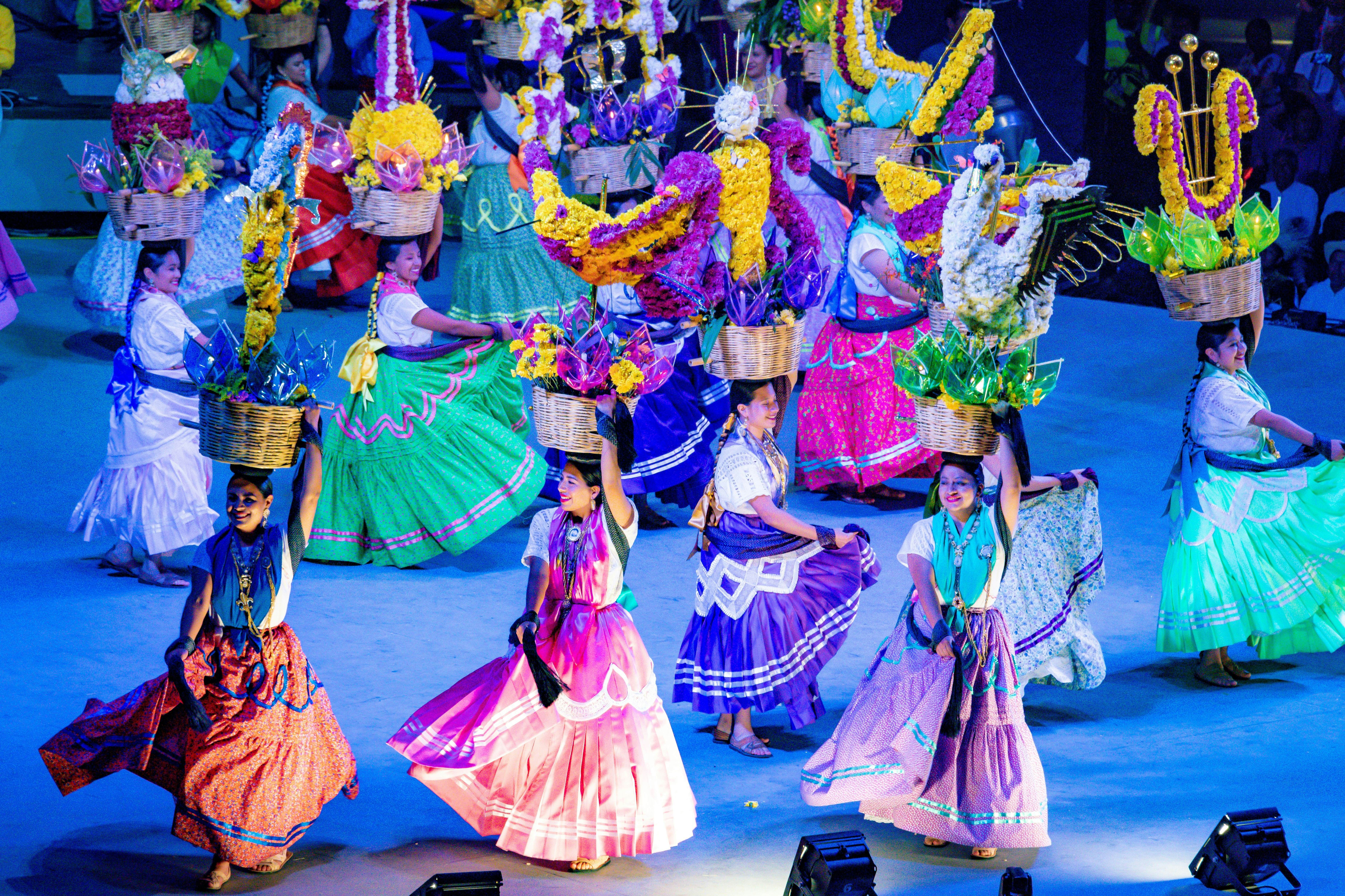 MEXICO, MX - Jul 18, 2019: A group of young females in colorful dresses dancing with baskets full of flowers during Guelaguetza, License Type: media, Download Time: 2025-10-09T02:15:51.000Z, User: bhealy950, Editorial: true, purchase_order: 65050 - Digital Destinations and Articles, job: Lonely Planet Online Editorial, client: Best things to do in Oaxaca, other: Brian Healy