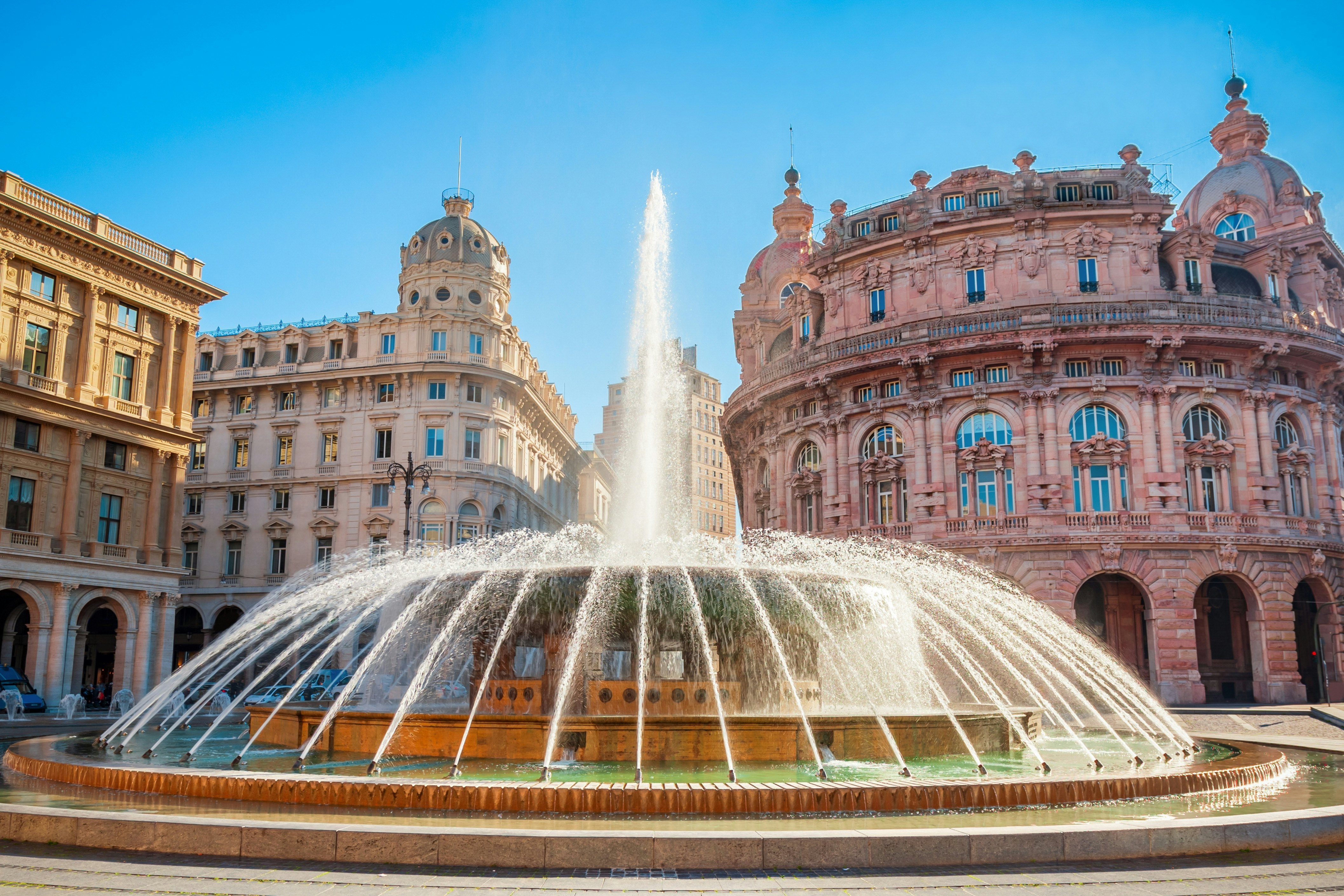 Fountain at the Piazza De Ferrari in Genoa, with ornate buildings in the background