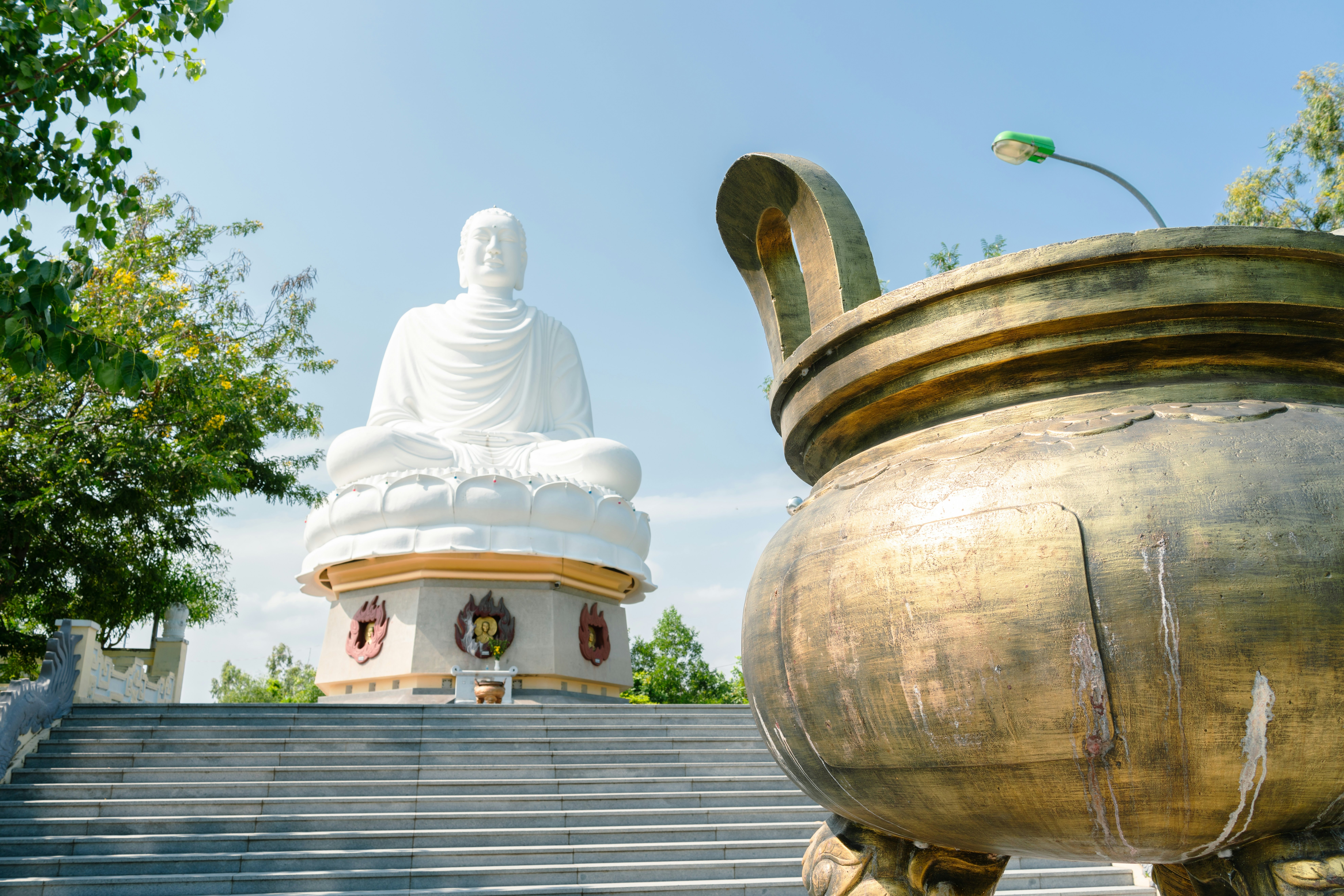 A view of a staircase with a large buddha statue at the top