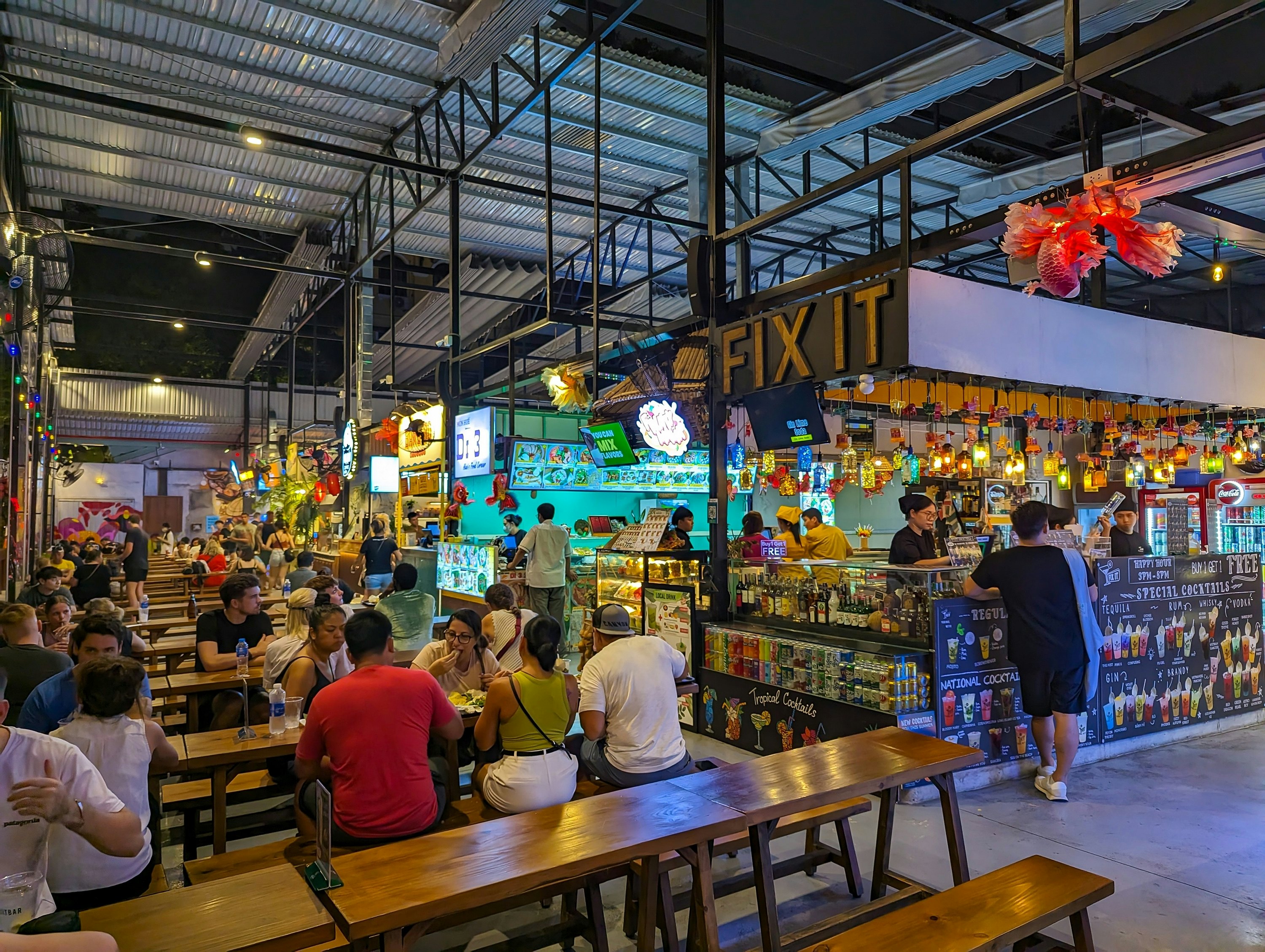 Diners at Ben Nghe Street Food Market wearing casual clothing