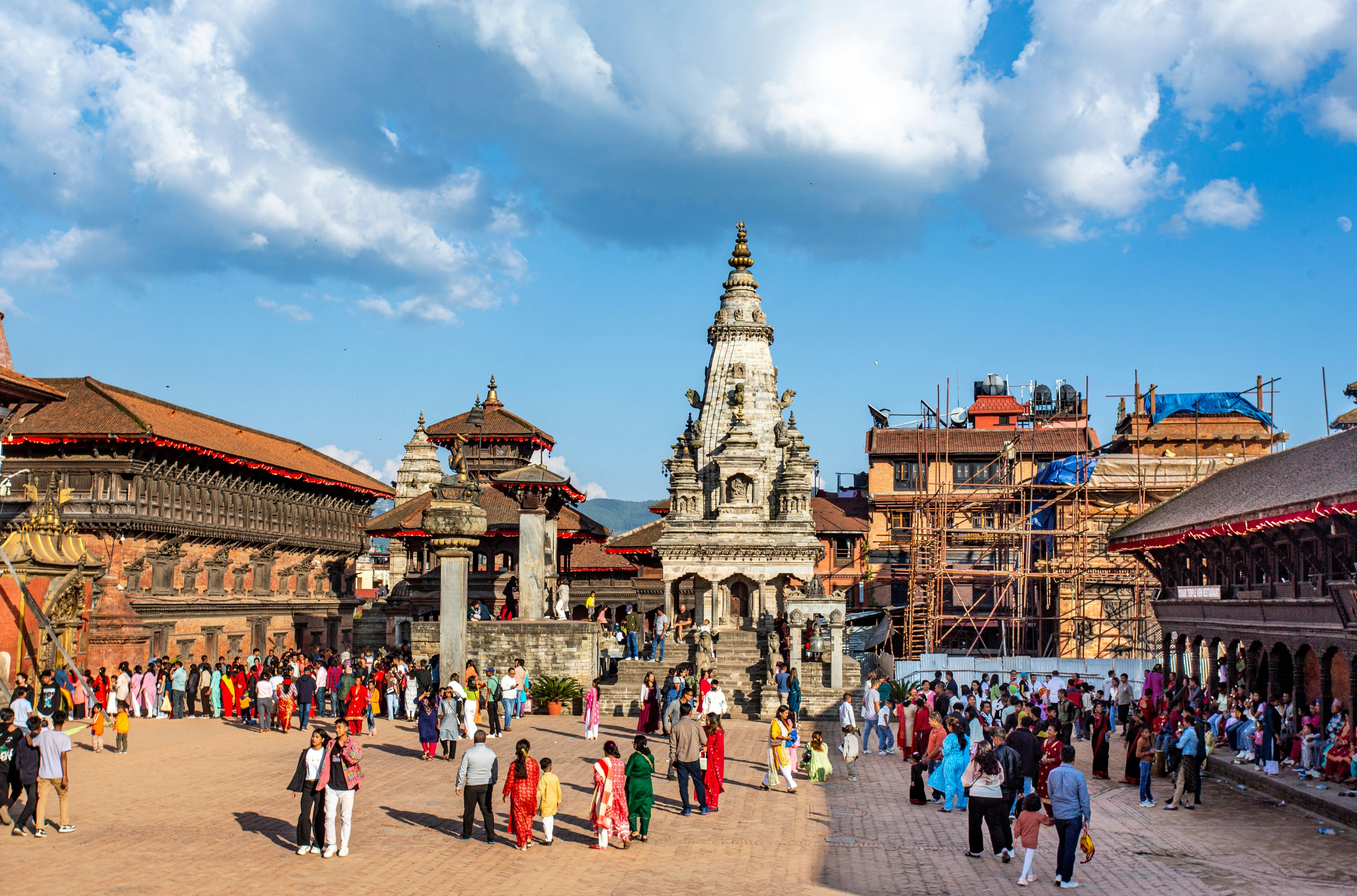 A busy city square surrounded by temples and stupas.