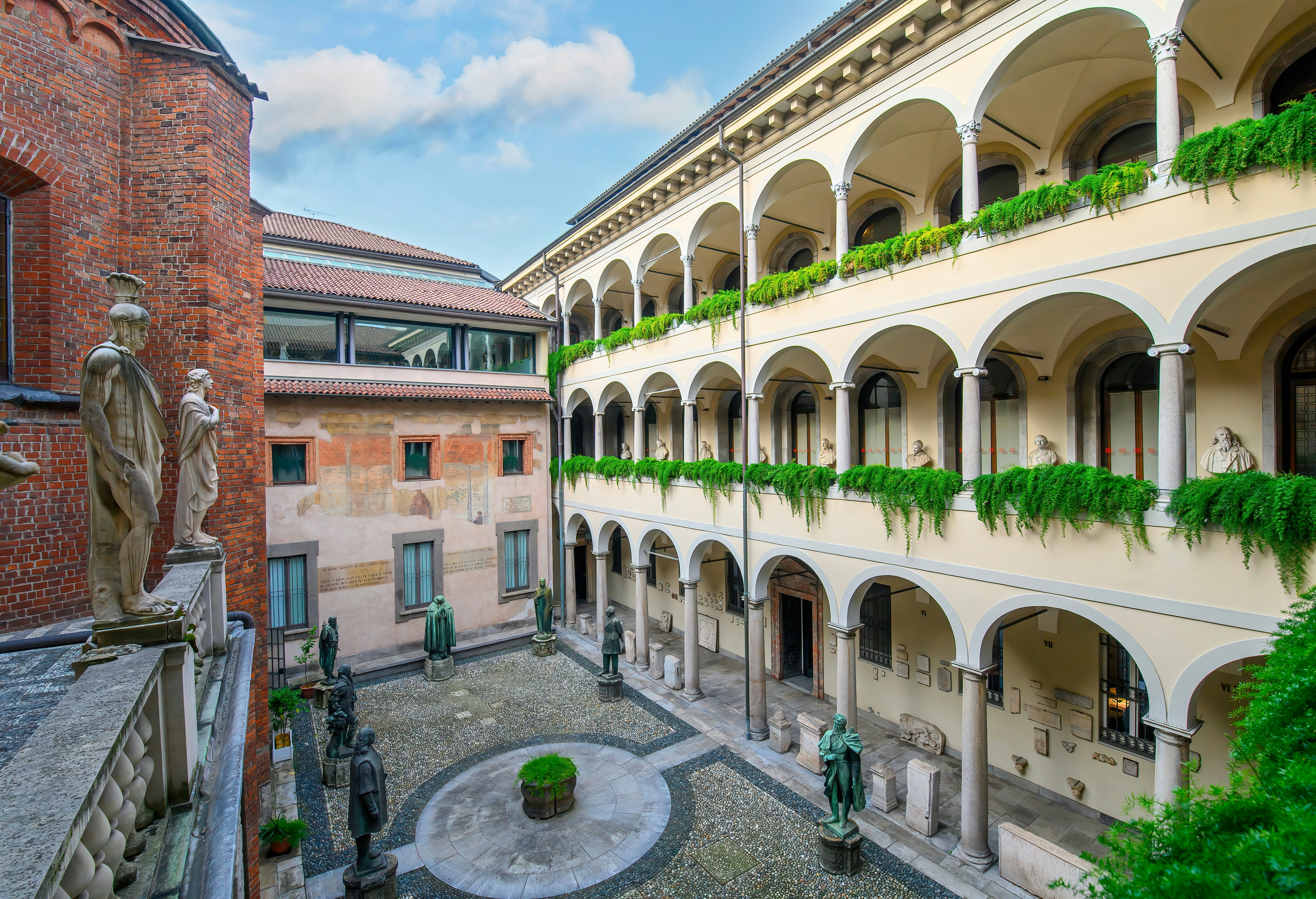 A sculpture-lined courtyard with cloisters.