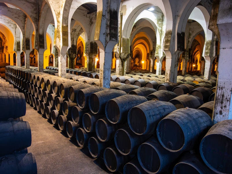 Andalusian wine cellar with stacks of barrels of wine and sherry