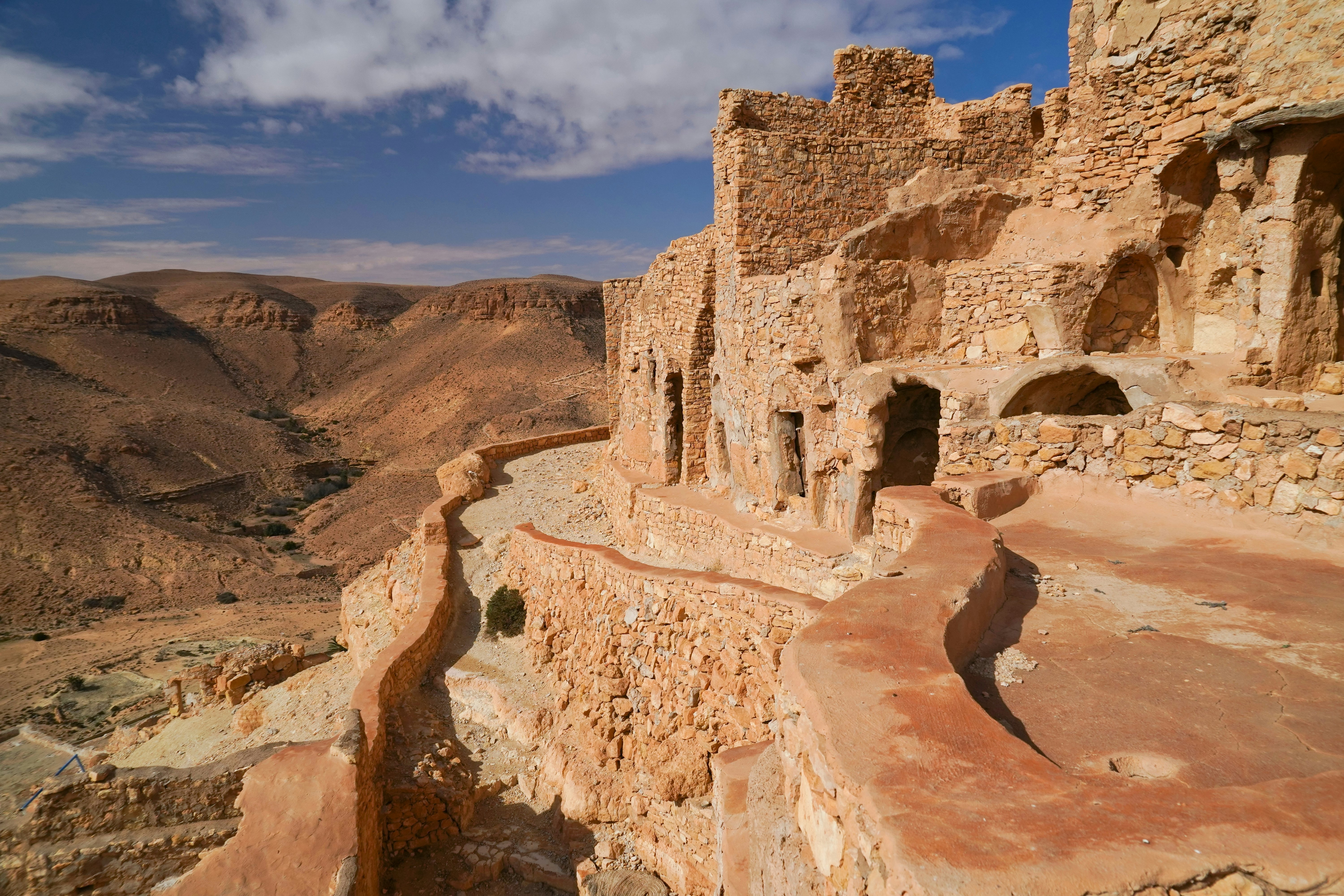 A series of cave dwellings built into the side of a hill.