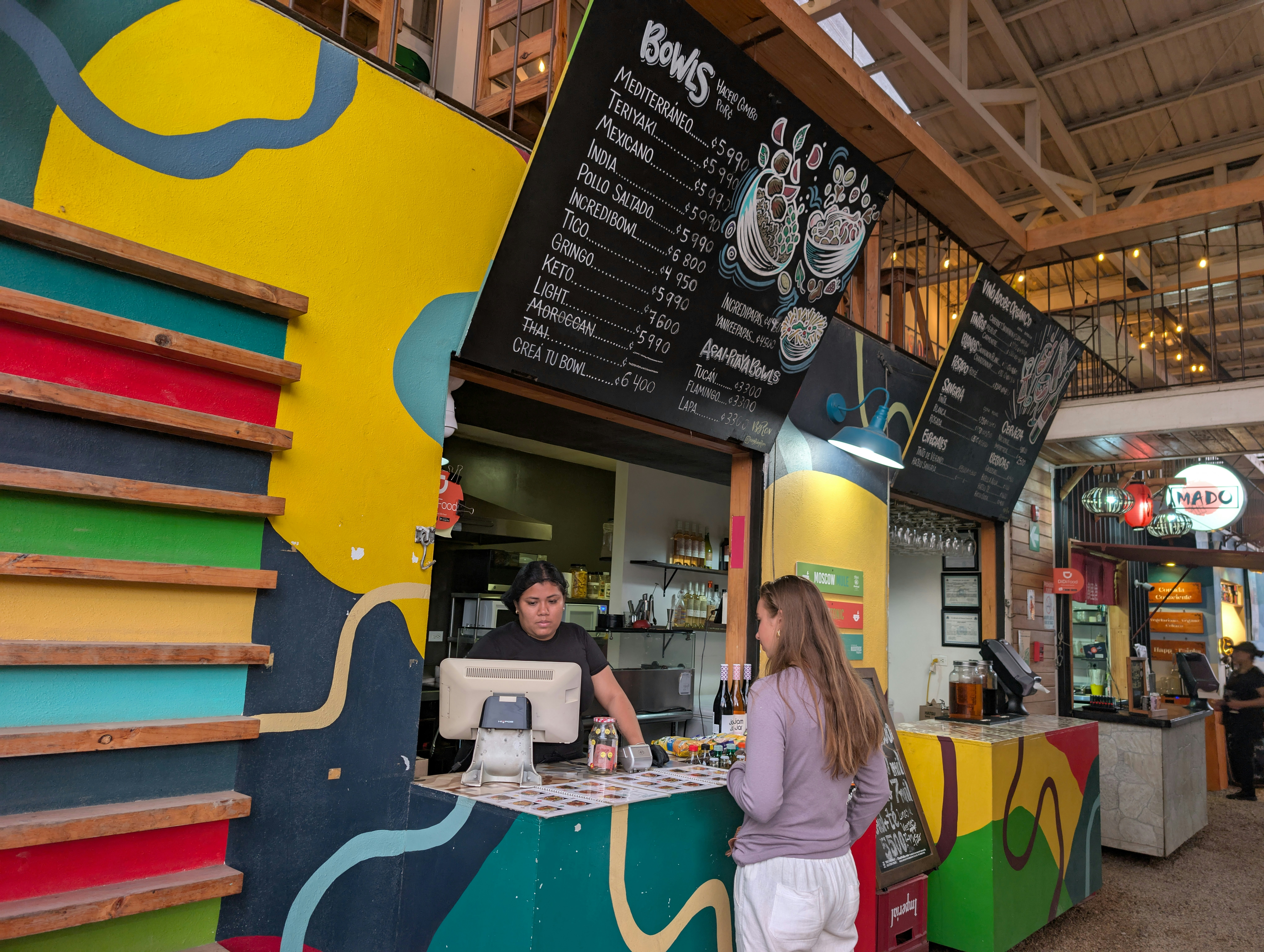 Customer and cashier in a colorful food court