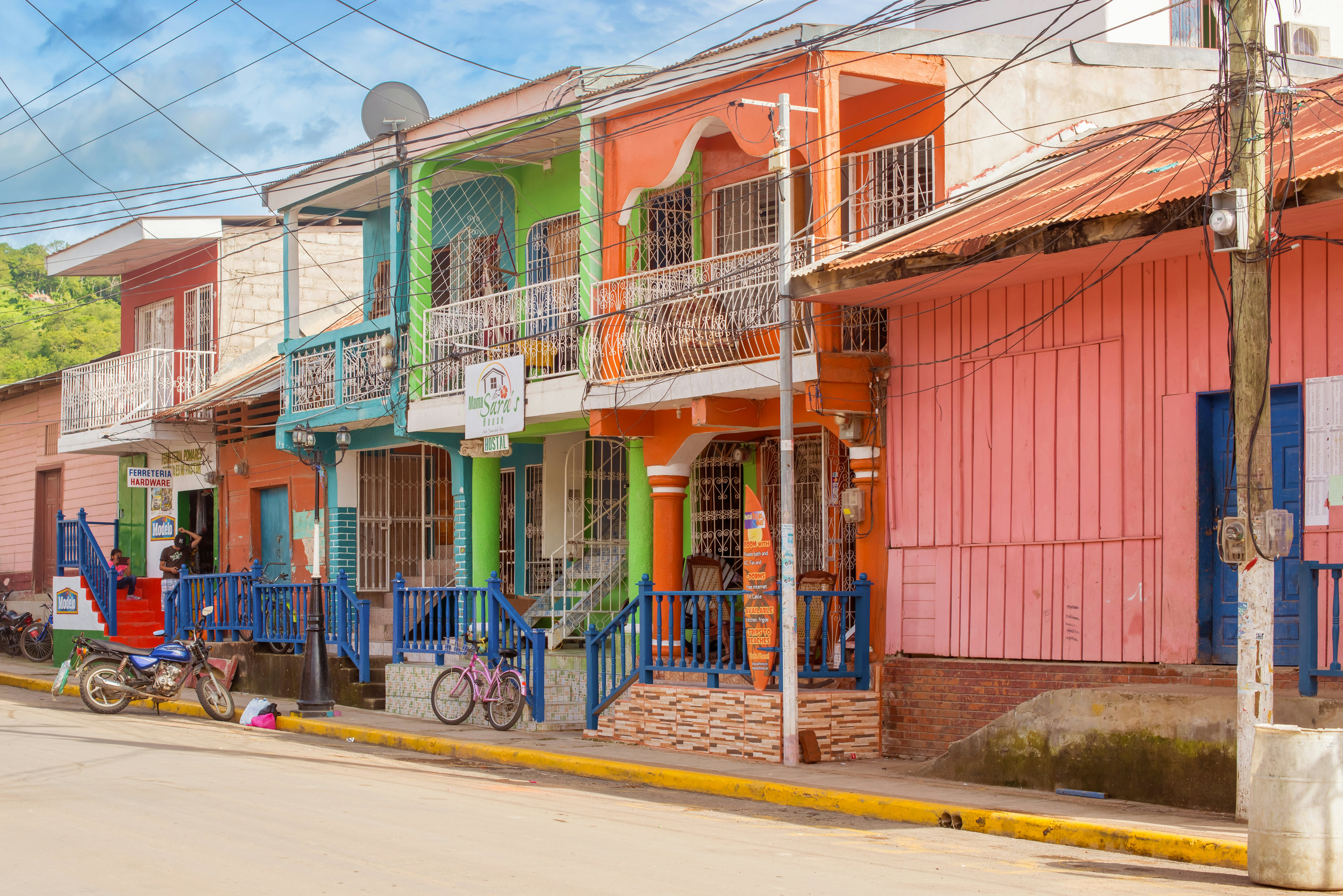 Colorful homes with bikes leaning against their gates.