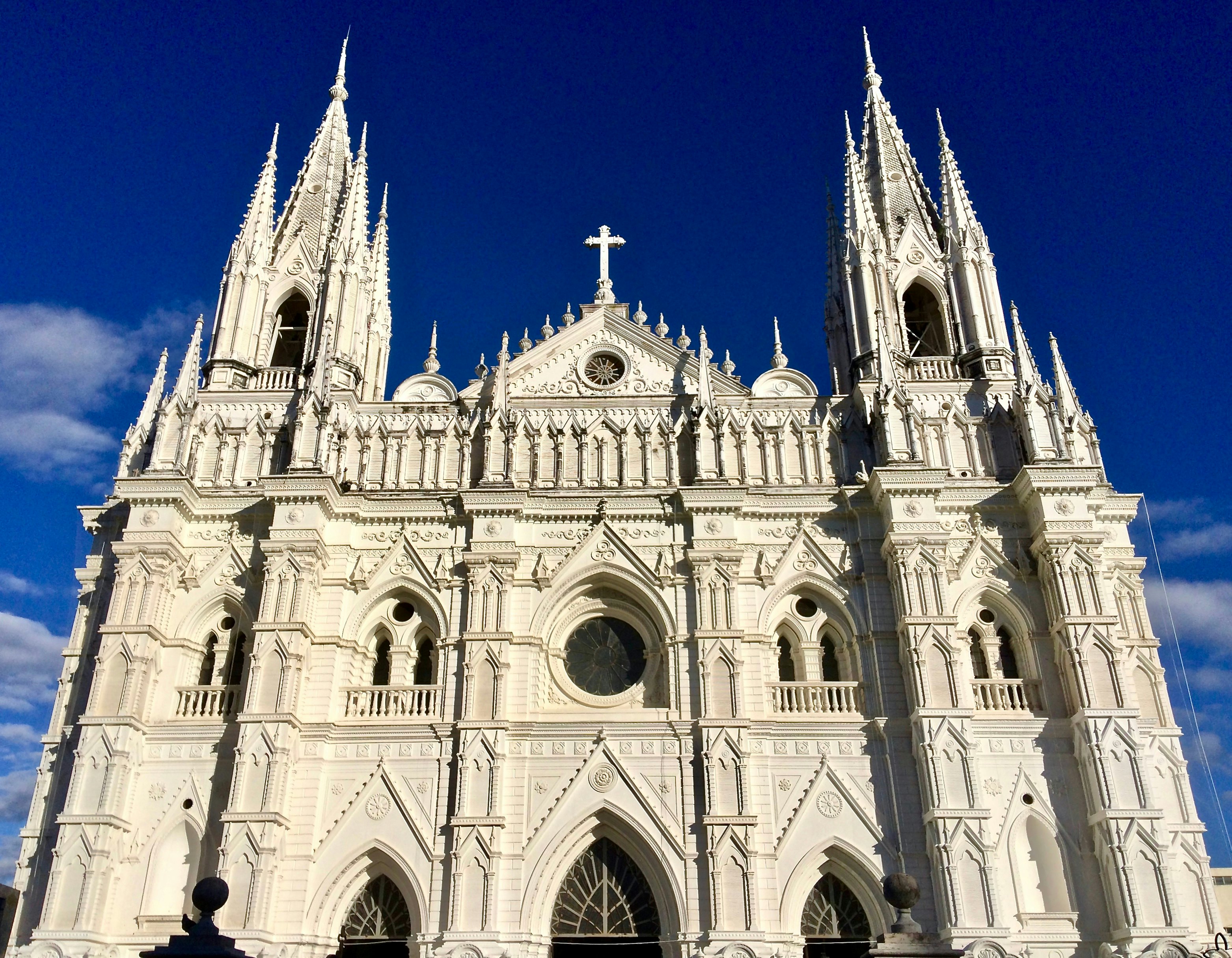 The white, ornate frontage of a large cathedral