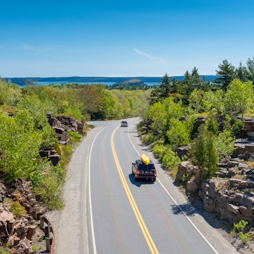 Cars driving on road in Acadia National Park, Maine, USA. One car holds a canoe on its roof.
529670940
Outdoor Pursuit, Eastern USA, Beauty In Nature, Water Sports Equipment, Bar Harbor, Acadia National Park, The Way Forward, Canoe, On The Move, Adventure, Exploration, Sport, Nature, Outdoors, Horizontal, Water Sport, Maine, New England - Usa, USA, Tree, Day, Springtime, Rock - Object, Landscape, Water, Road, Thoroughfare, Car
CLEARED FOR DIGITAL USE ONLY -