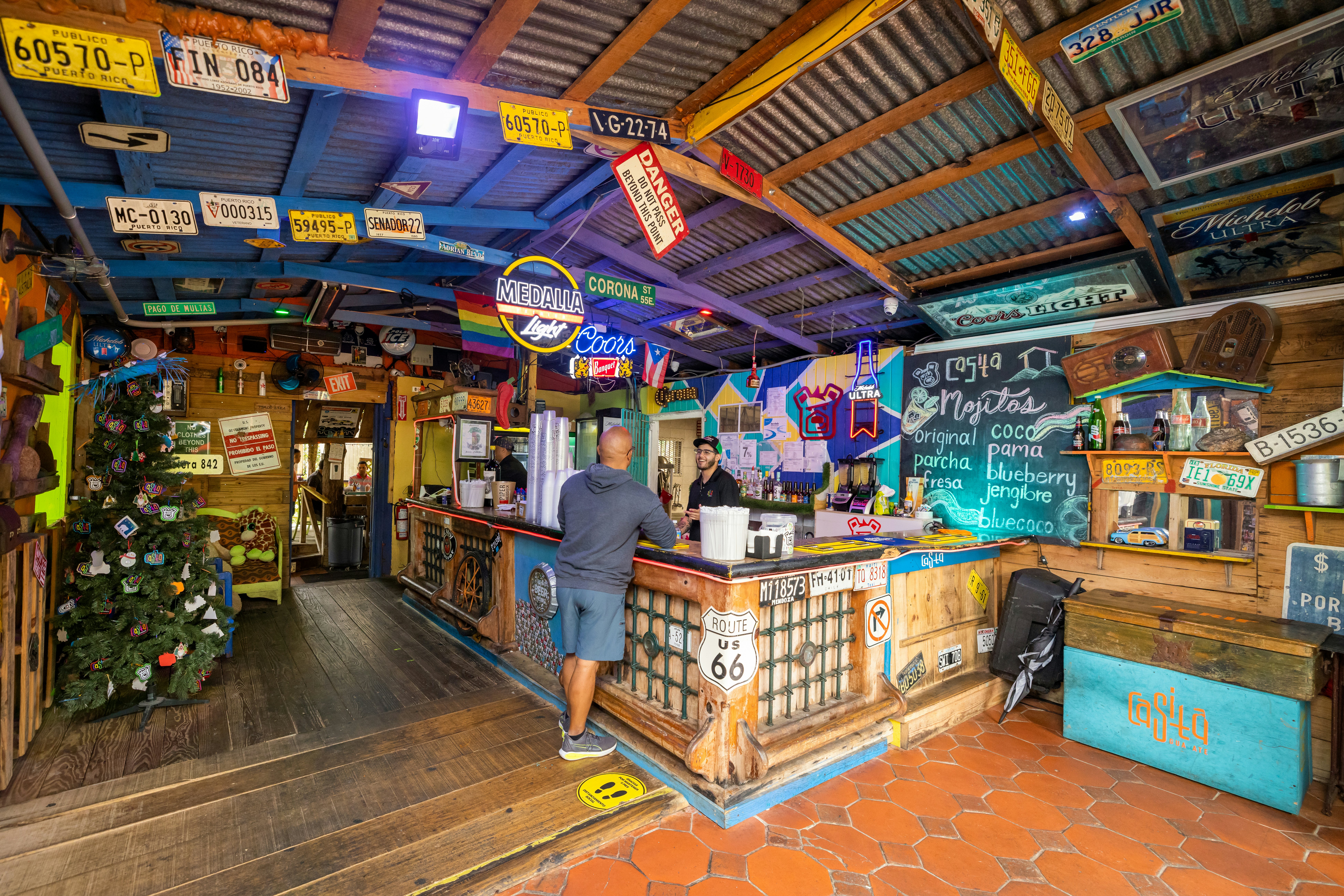 A man orders from a counter in a colorful, casual eatery.
