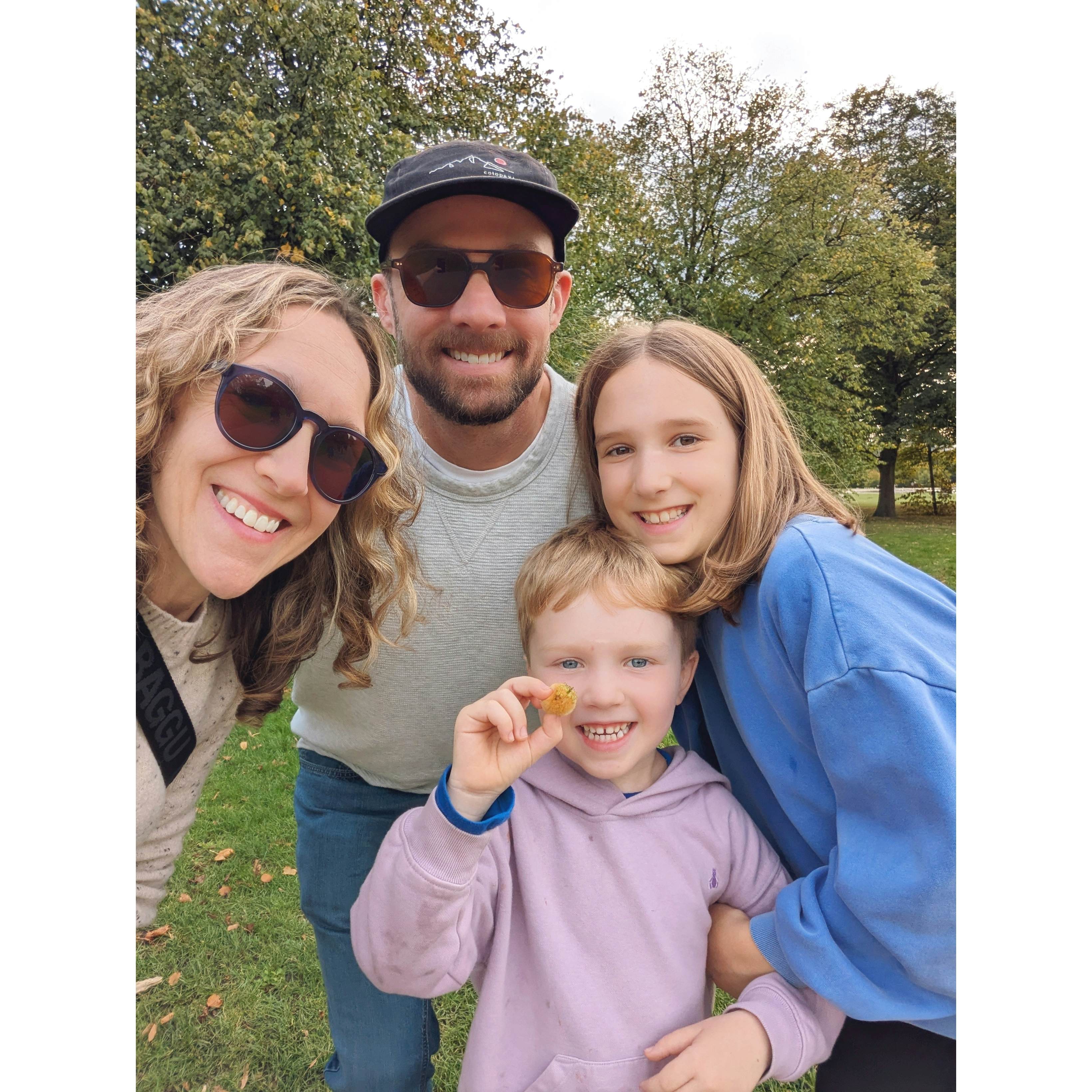 A woman, a man and two children smile for a selfie.