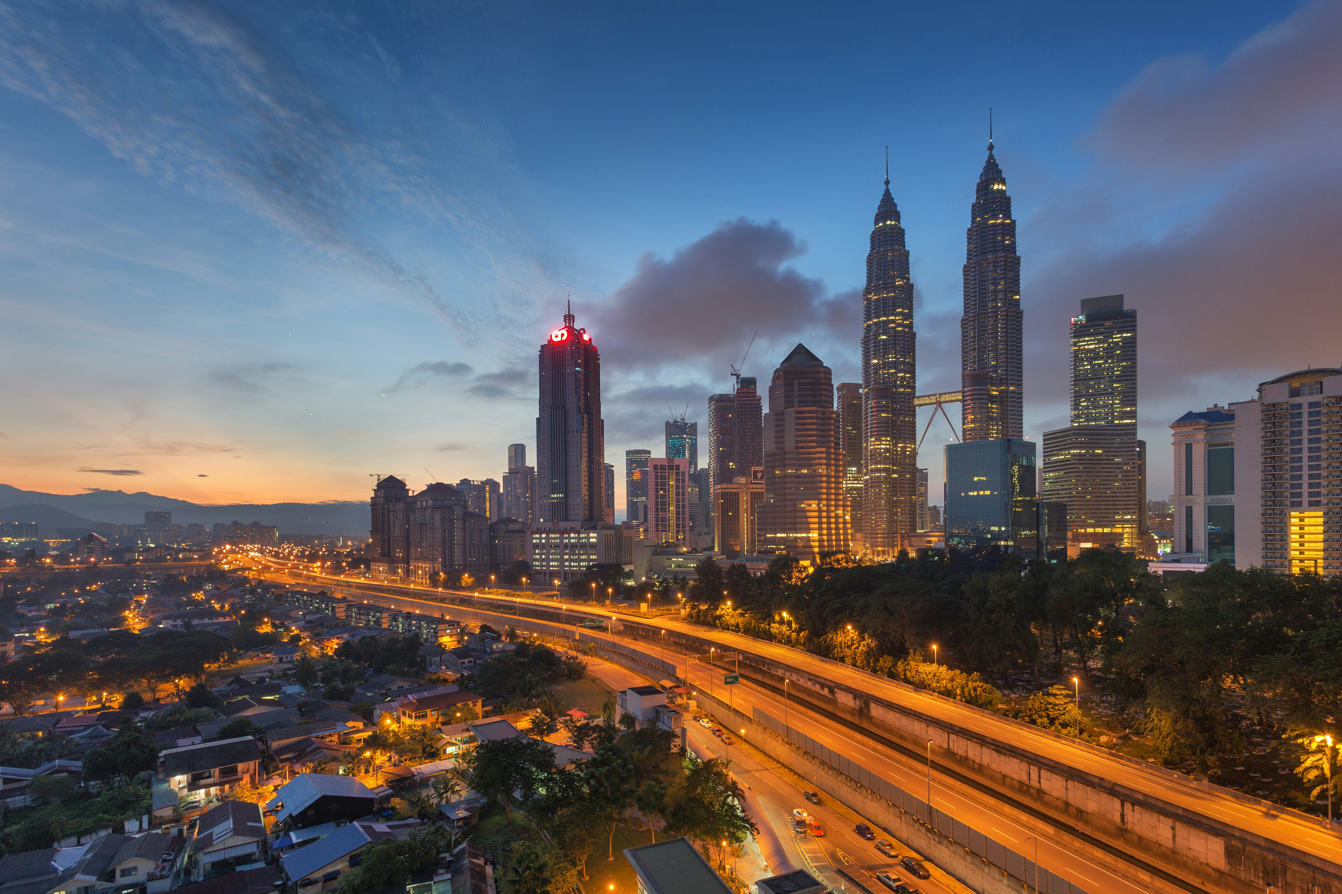 The skyline of Kuala Lumpur with the Petronas Towers, seen from Kampung Baru in the early morning, Malaysia.
