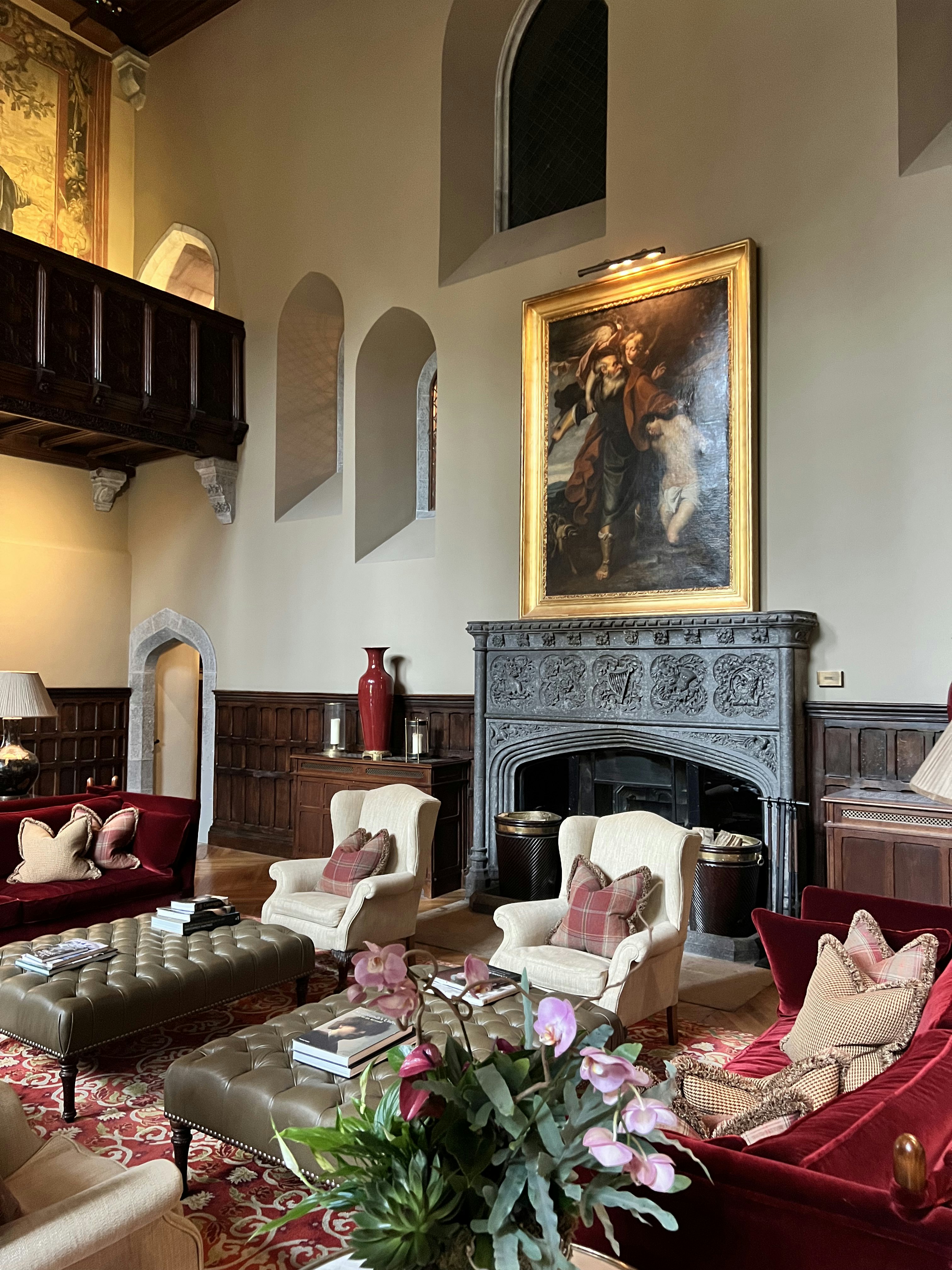 The lobby of a grand luxury hotel, with comfortable seating and a large fireplace.