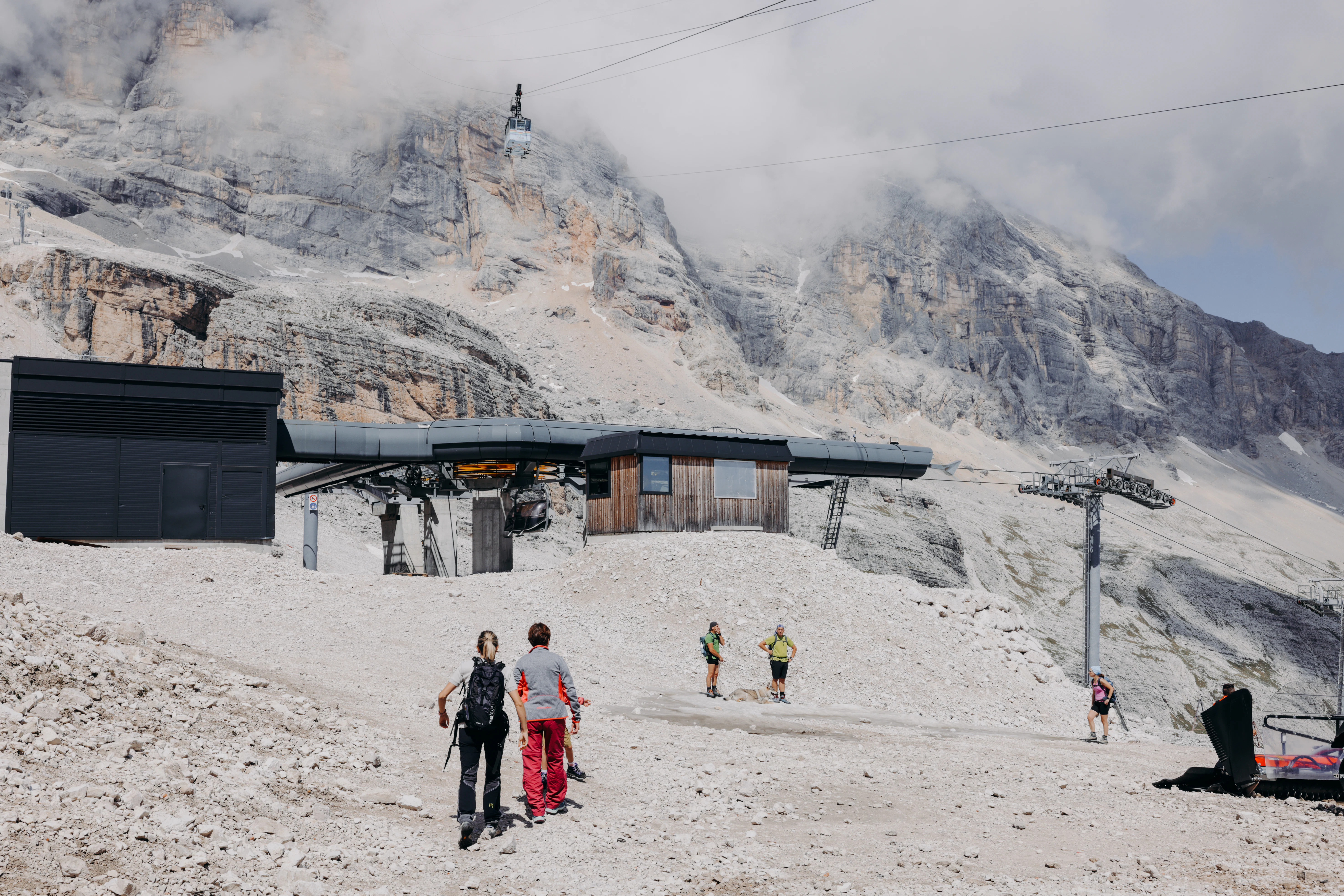 Hikers by the top station of the Freccia nel Cielo in the Dolomites near Cortina d'Ampezzo, Italy.