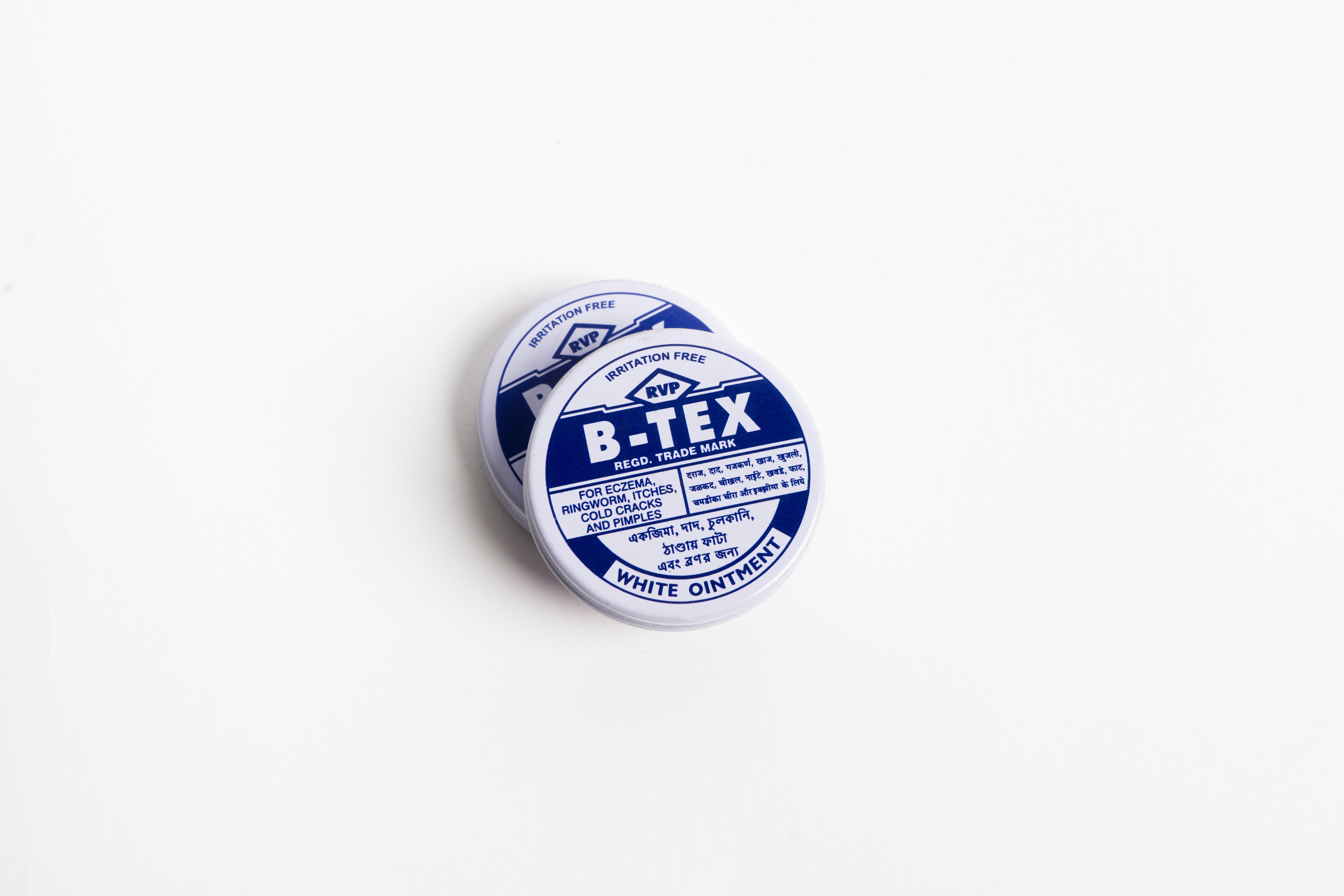 A tin of ointment. The tin is designed with blue and white text.