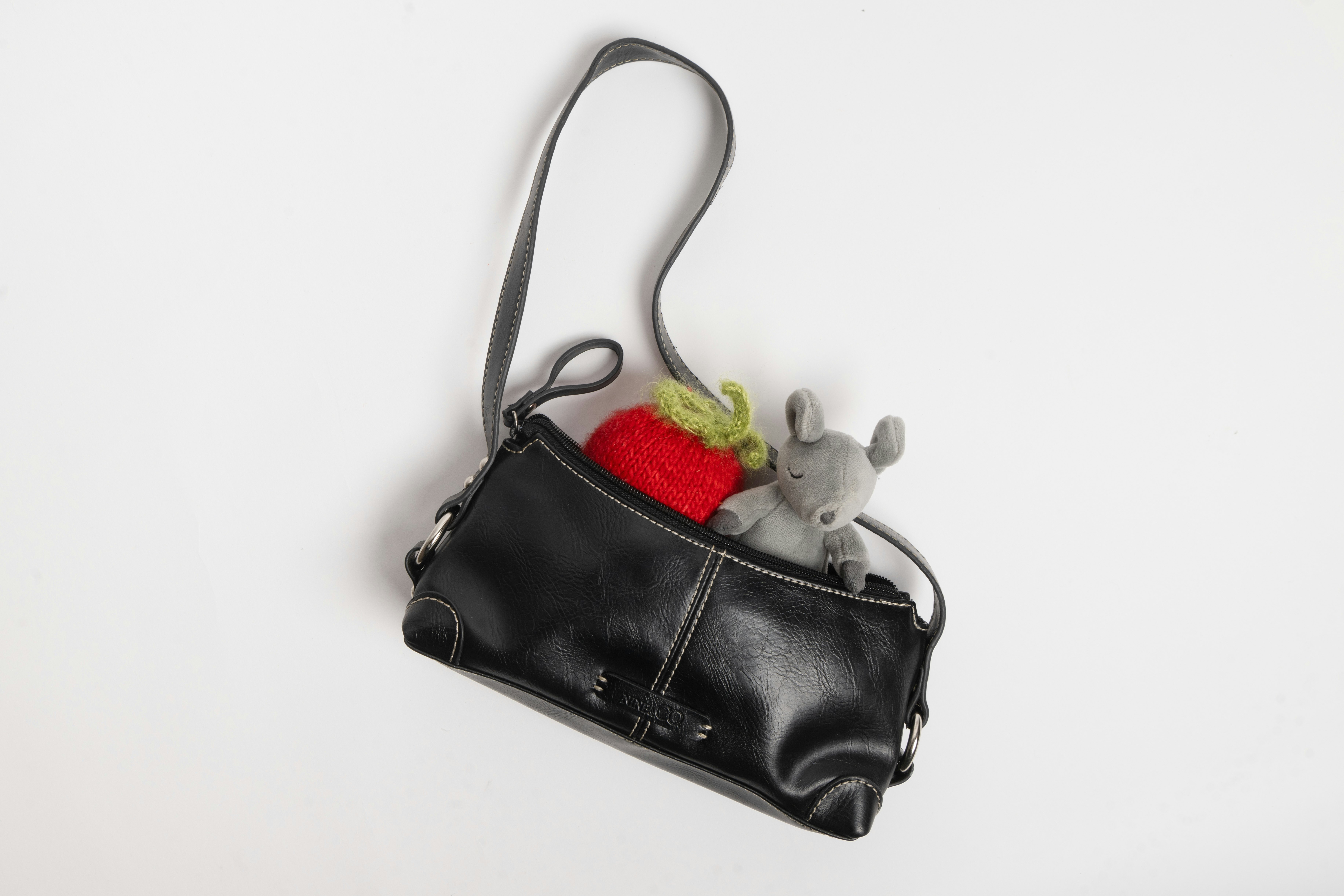 A tiny purse with dolls in it.