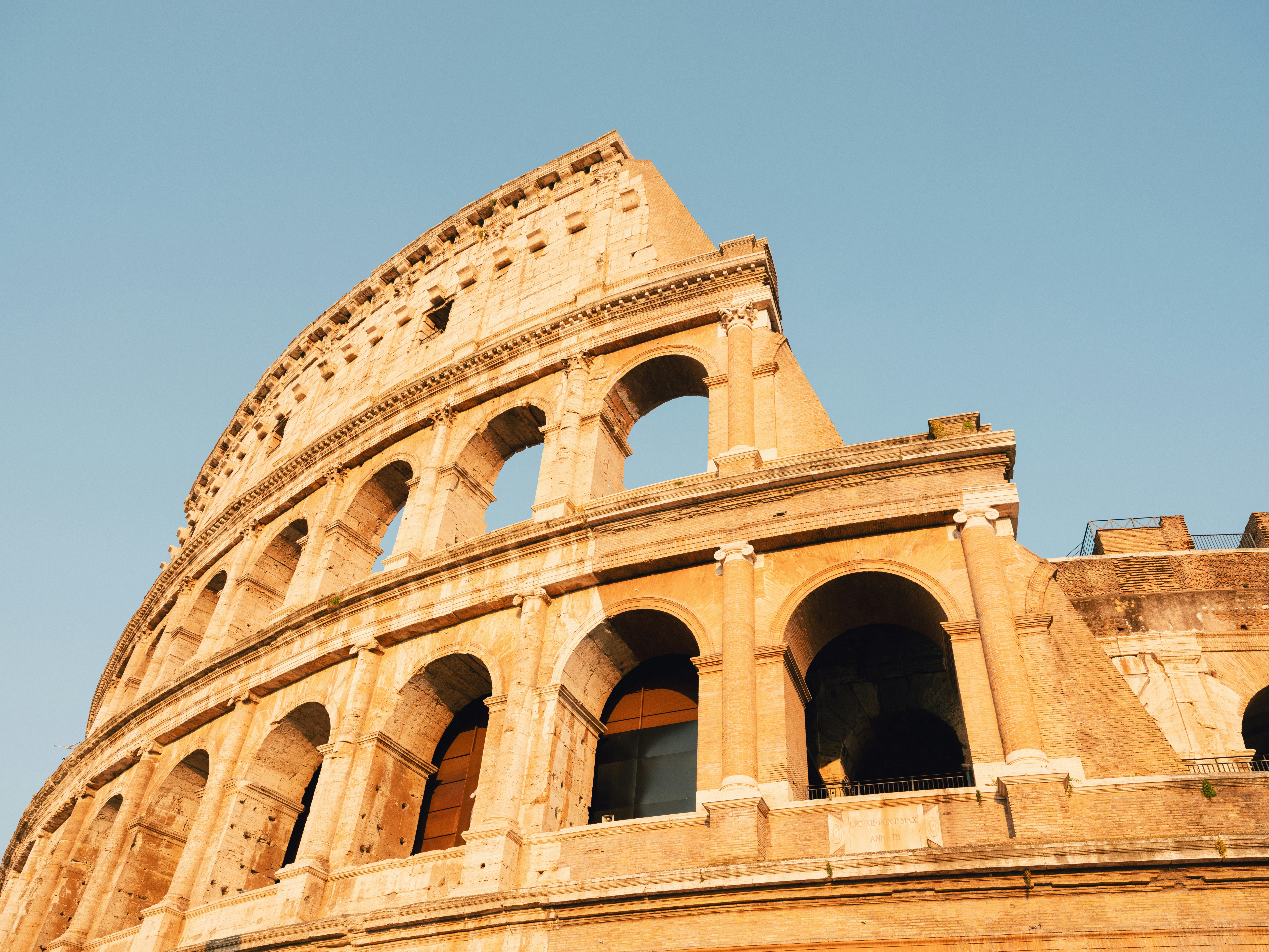 A view looking up at the columns of the Colosseum in Rome