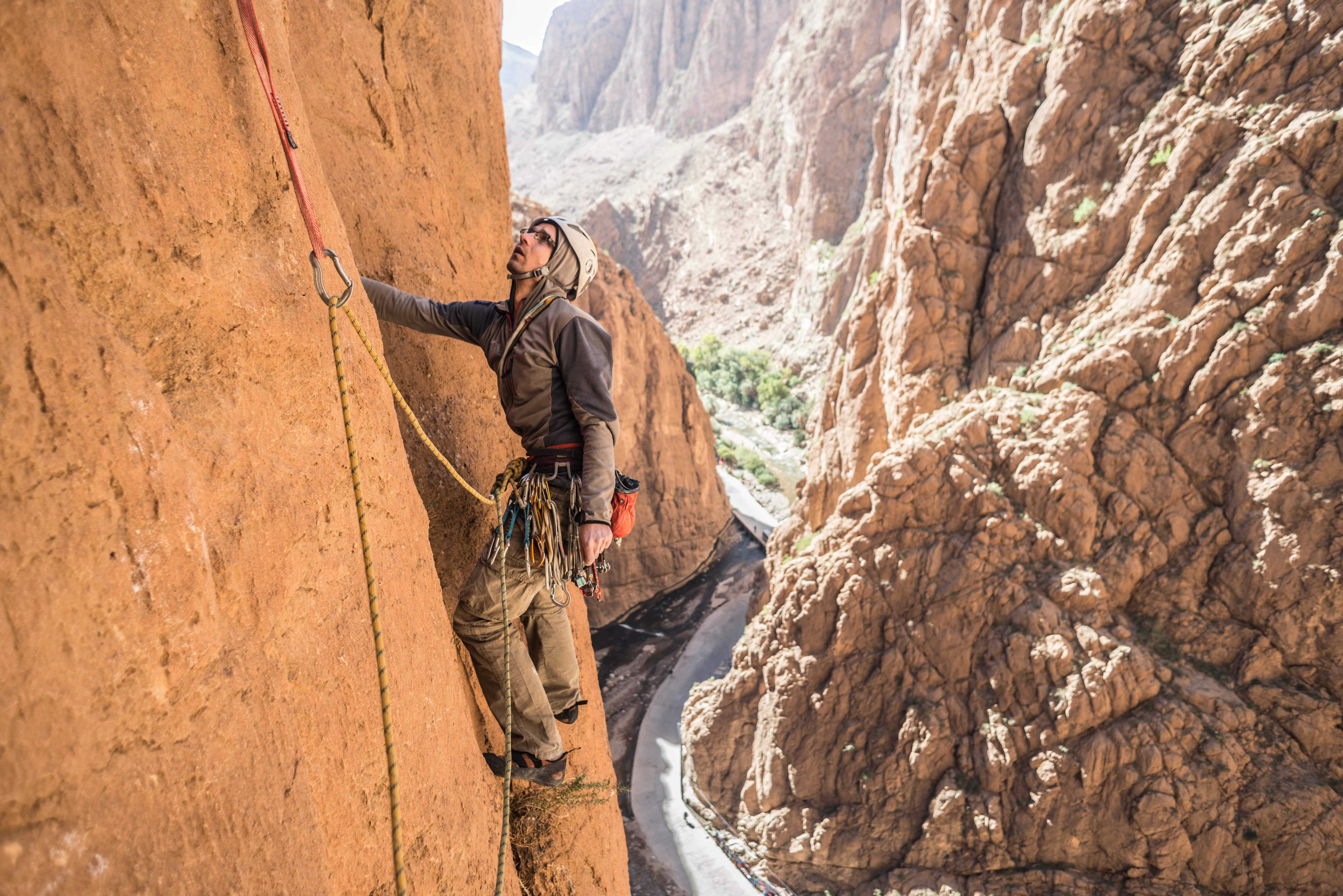 Man rock climbing in Todra Gorge in the Atlas Mountains, Morocco