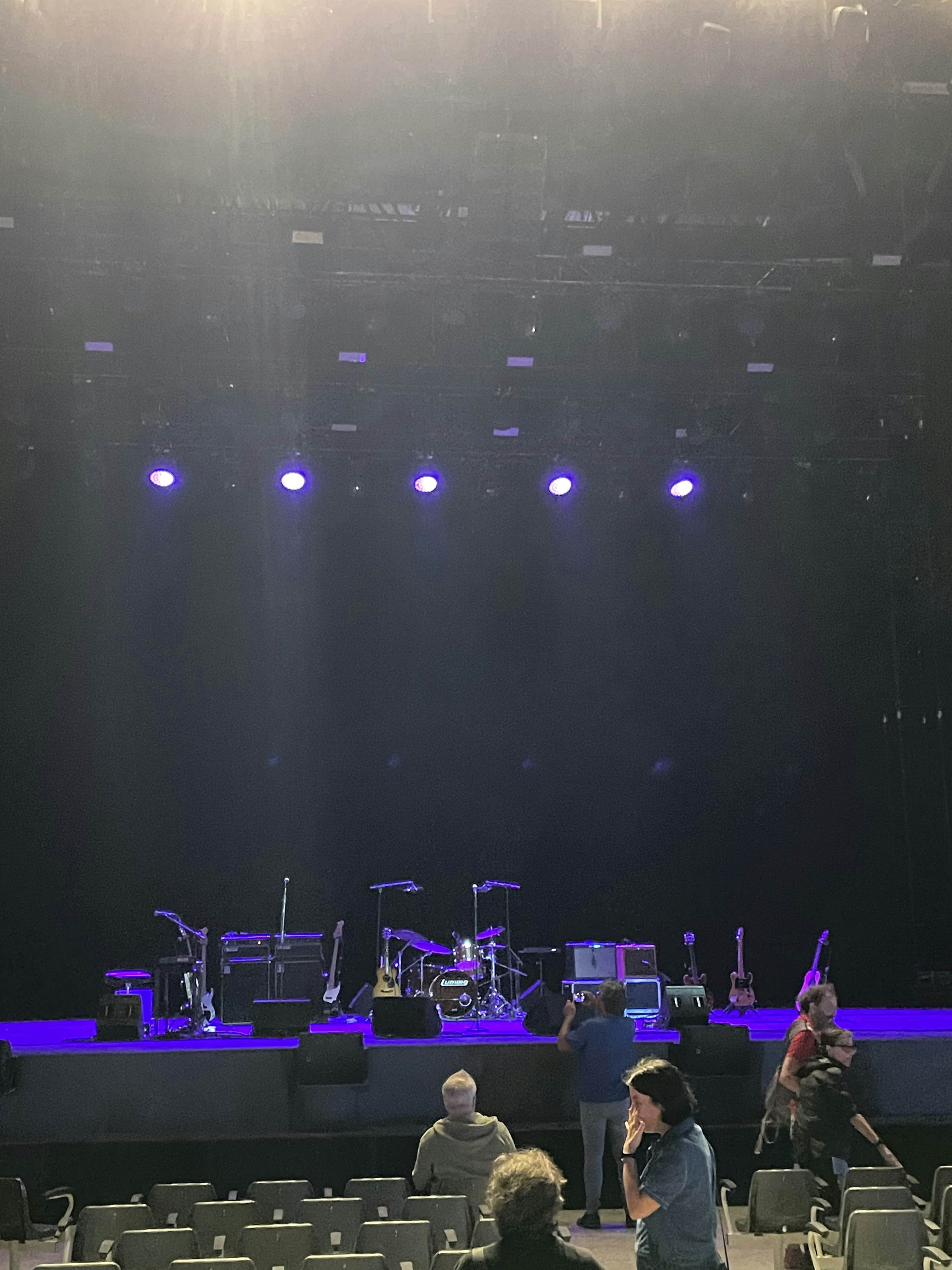 A stage with musical instruments illuminated in blue