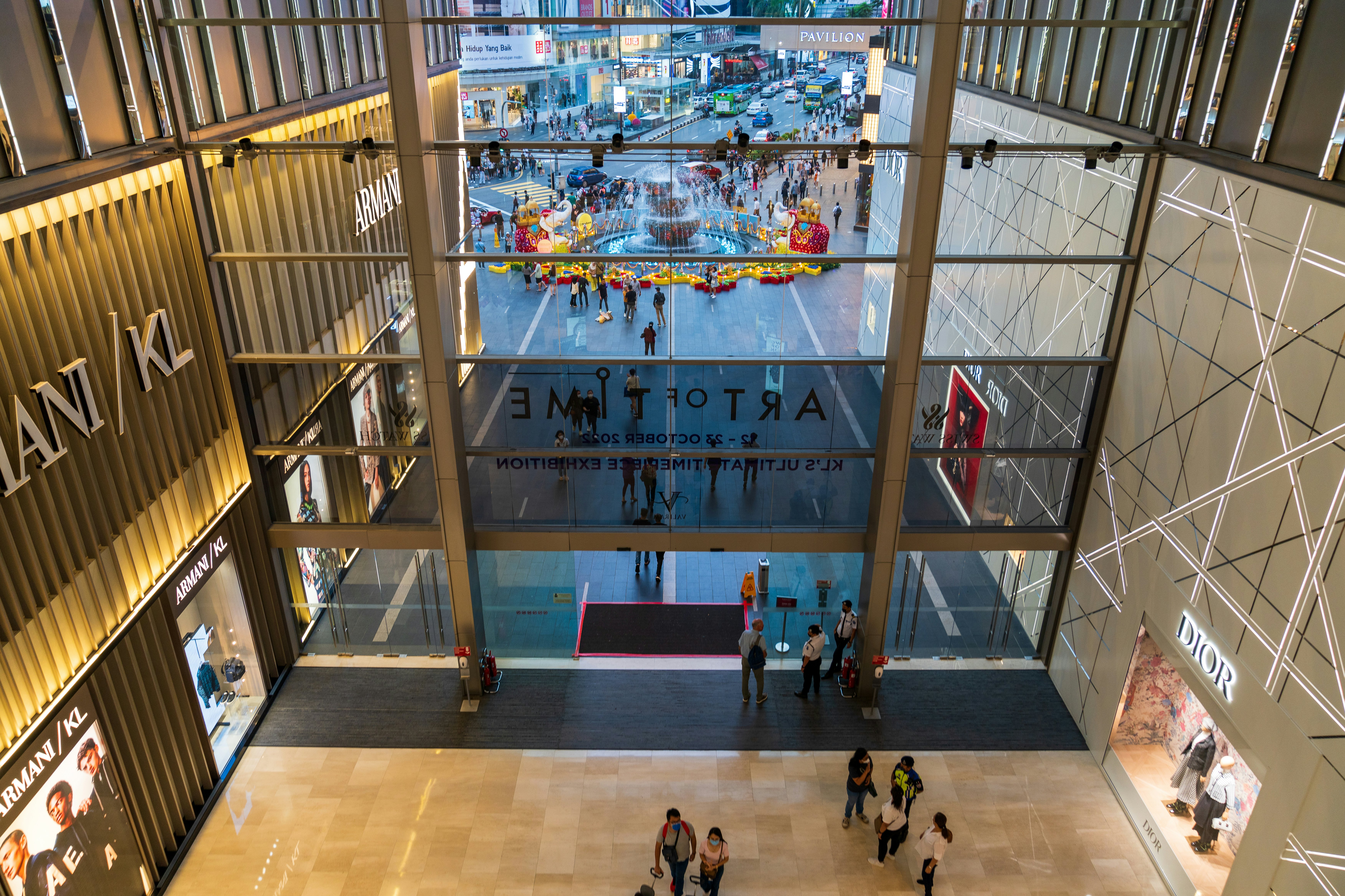 The atrium of a luxury mall is pictured from an upper floor.