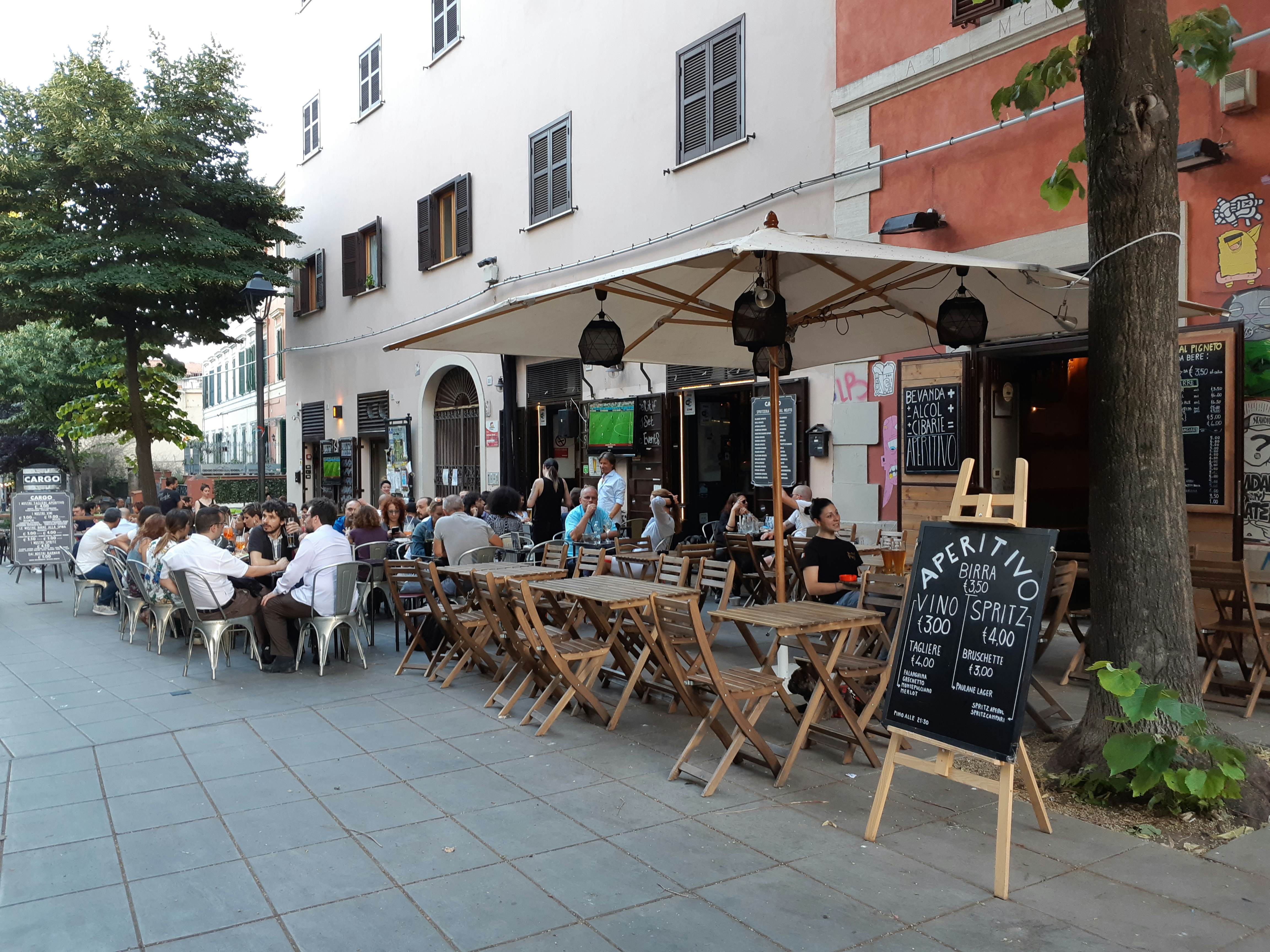 The outdoor patio of a wine bar filled with customers