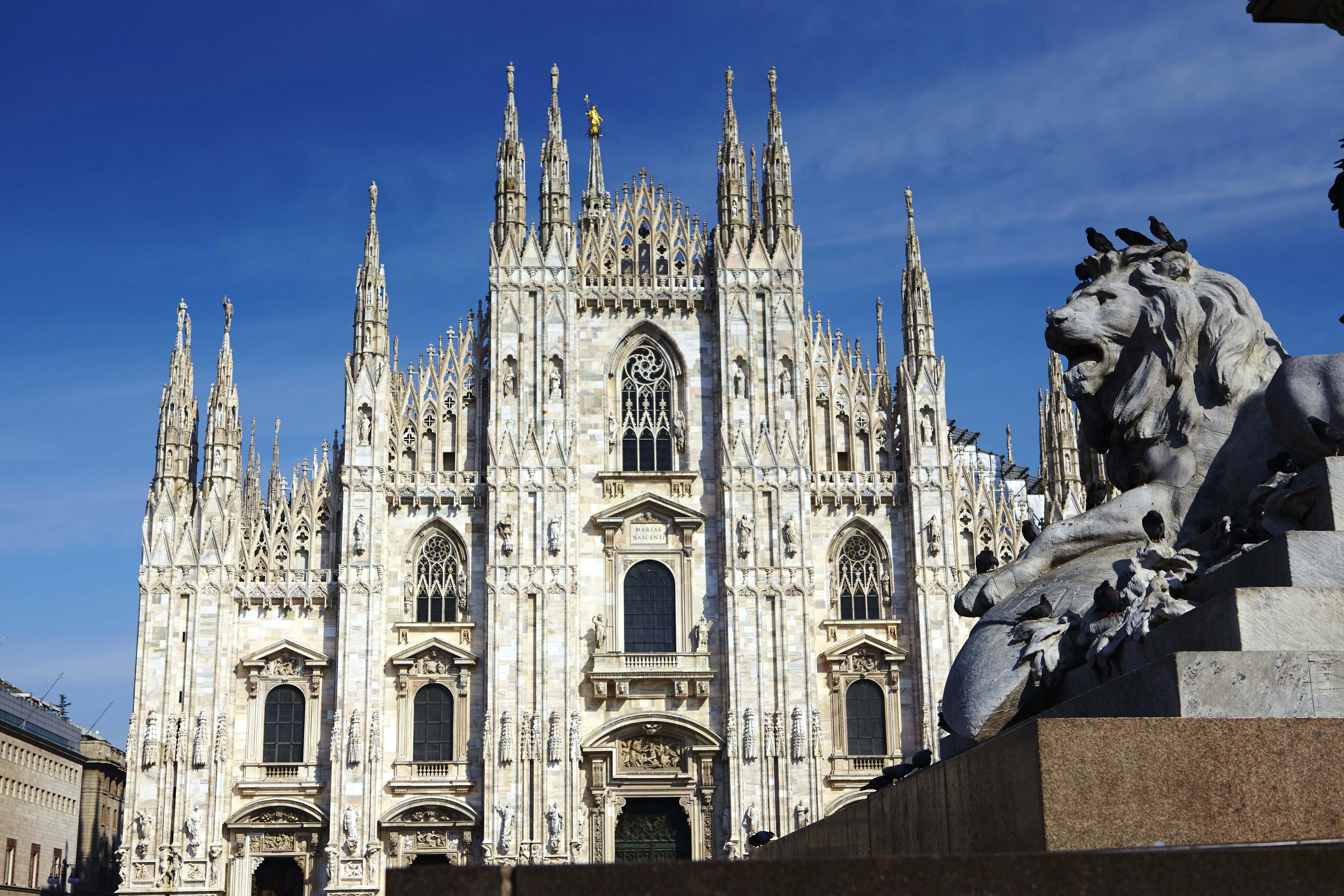 The grand frontage of the Duomo in Milan, Italy.