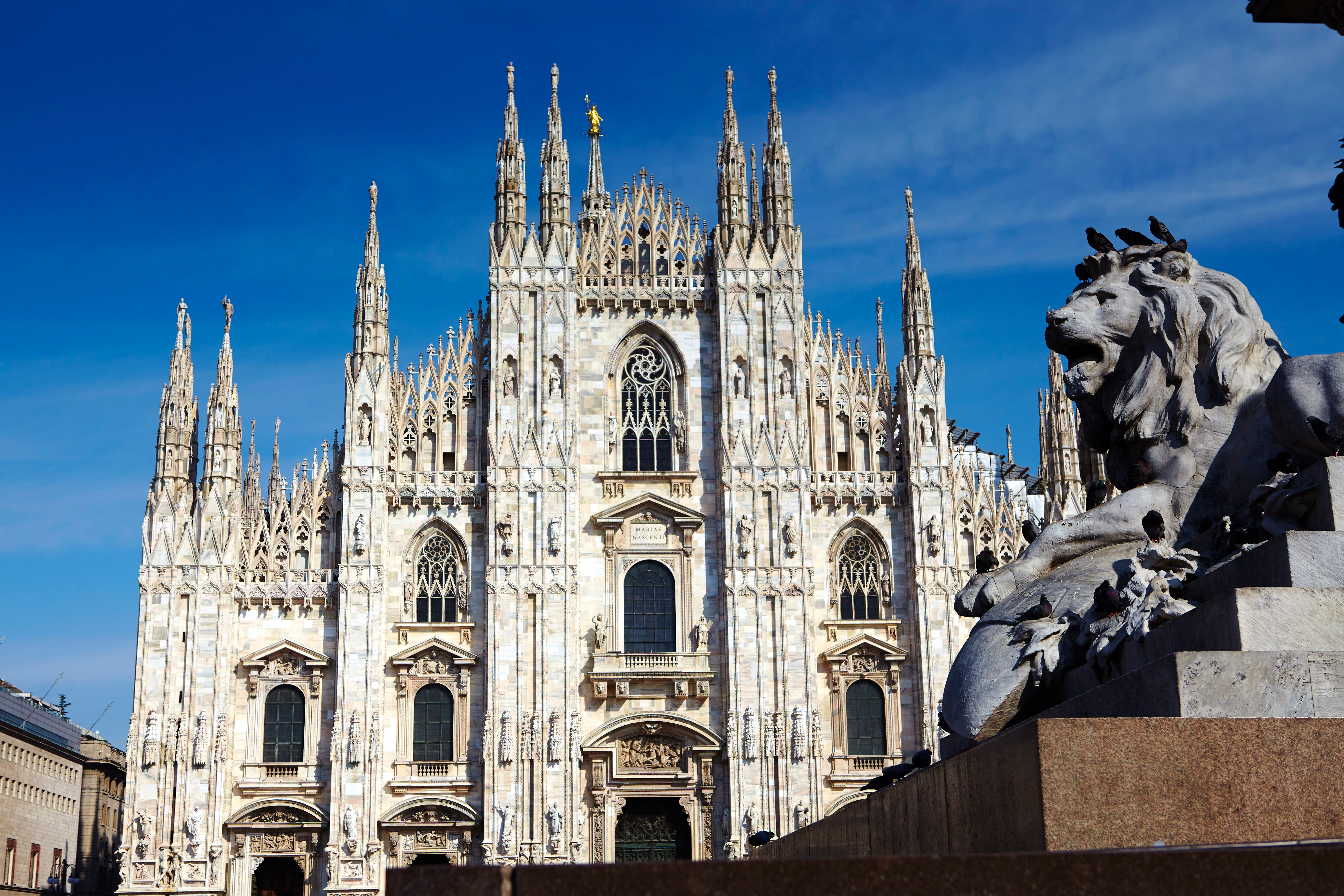 The grand frontage of the Duomo in Milan, Italy.