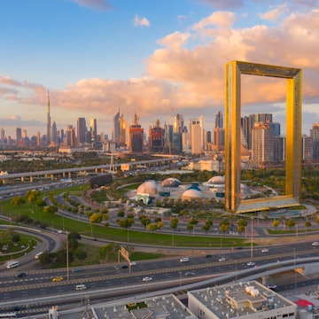 Aerial view of Dubai Frame, Downtown skyline, United Arab Emirates or UAE. Financial district and business area in smart urban city. Skyscraper and high-rise buildings at sunset. License Type: media Download Time: 2023-11-20T02:03:47.000Z User: mvm_lonelyplanet Is Editorial: No purchase_order: