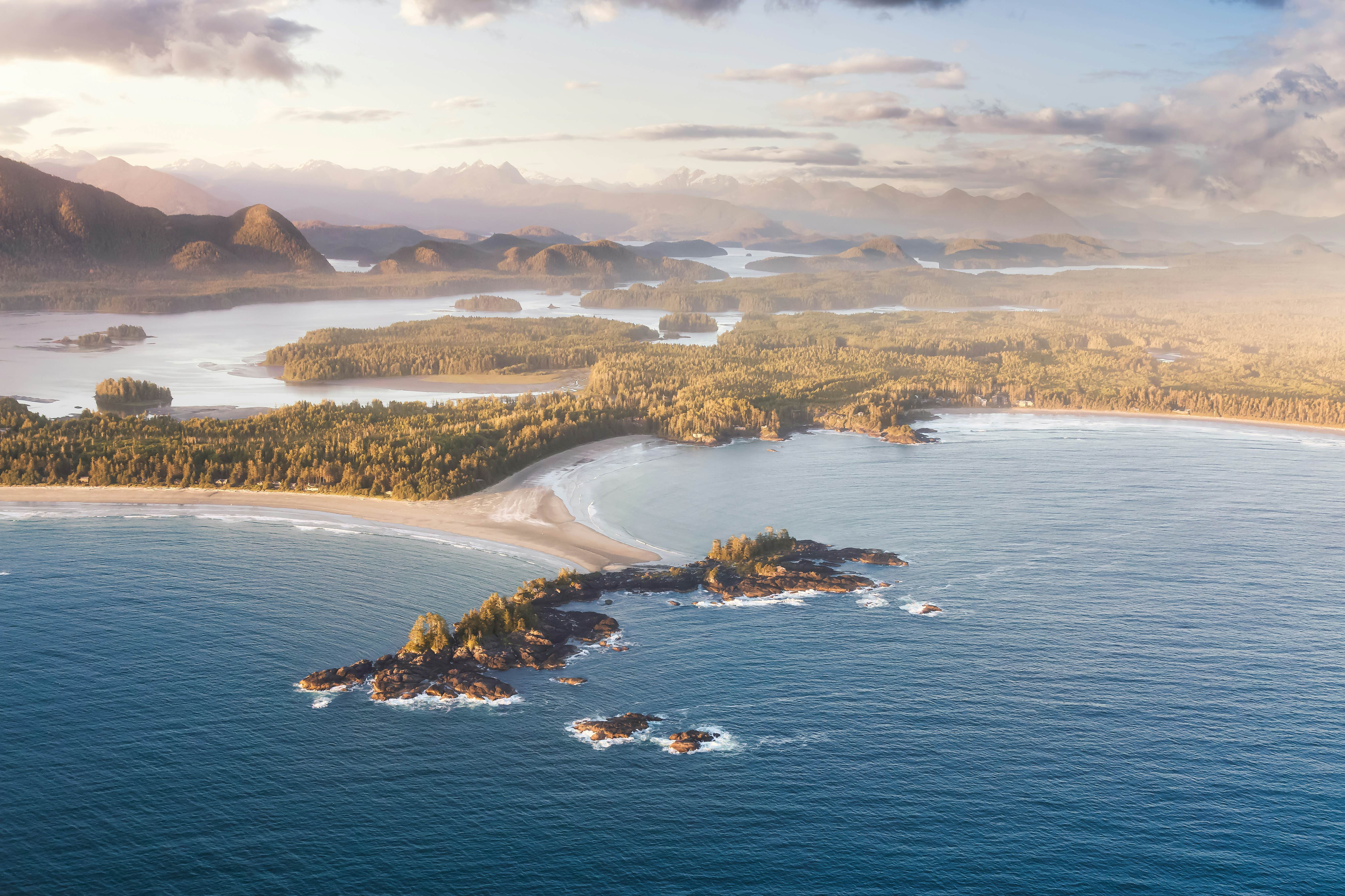 Aerial Canadian Landscape at the West Pacific Ocean Coast during a bright colorful vibrant sunset. Taken from Airplane in Tofino, Vancouver Island, British Columbia, Canada.  License Type: media  Download Time: 2022-07-06T01:17:56.000Z  User: claramonitto  Is Editorial: No  purchase_order:   