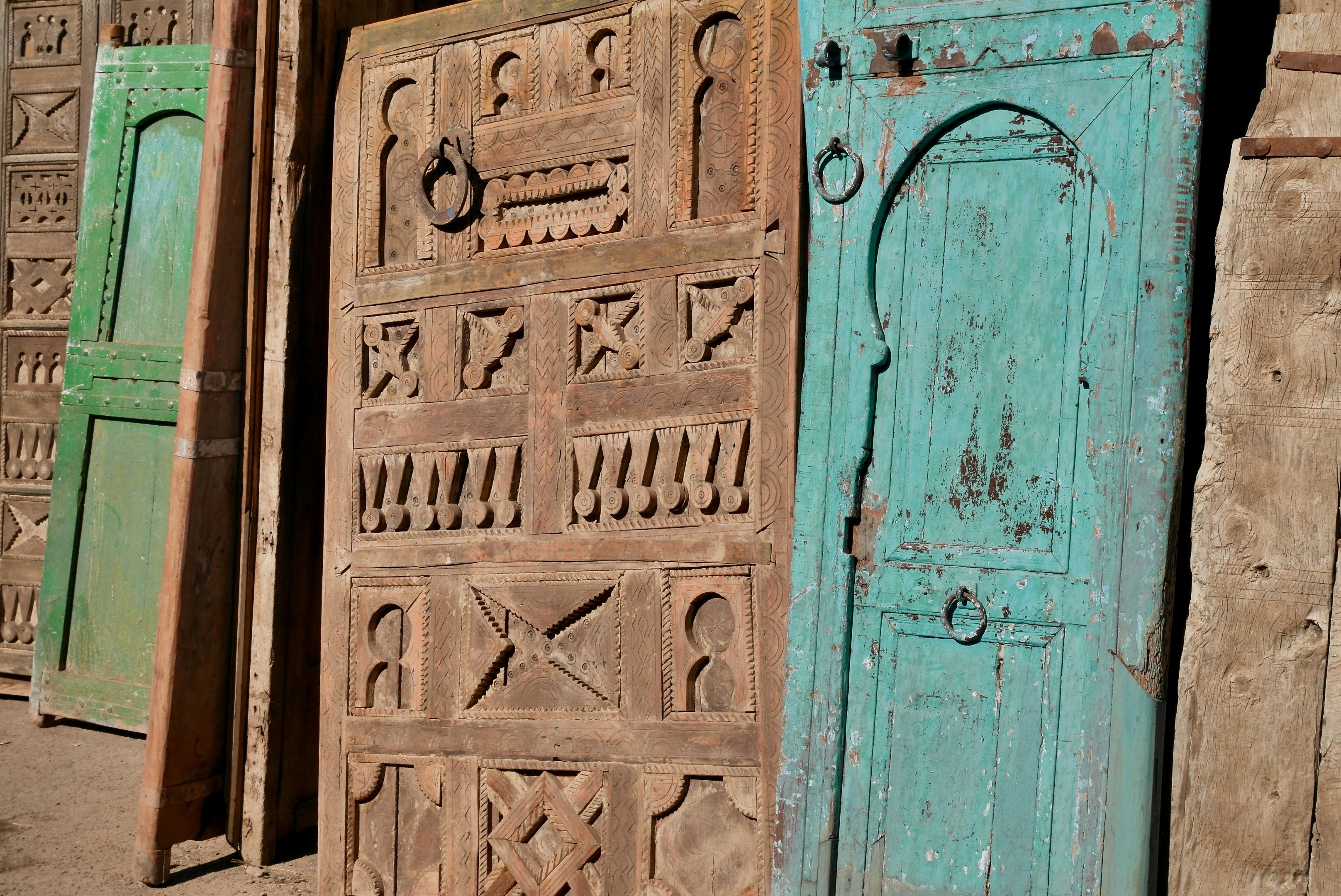 Beautiful old wooden doors on display for sale at Bab el Khemis flea market. Marrakech, Morocco