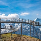 GRINDELWALD, SWITZERLAND - MAY 17, 2022 : View of sky cliff walk metal bridge at First peak above Grindelwald village. Jungfrau region, Switzerland. License Type: media Download Time: 2024-02-21T15:18:09.000Z User: Is Editorial: Yes purchase_order: