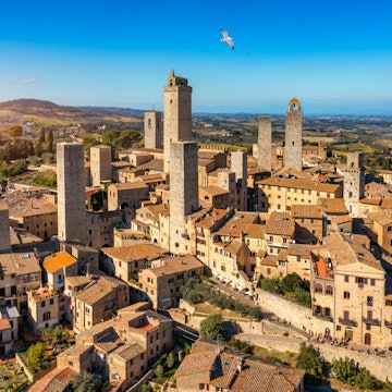 Town of San Gimignano, Tuscany, Italy with its famous medieval towers. Aerial view of the medieval village of San Gimignano, a Unesco World Heritage Site. Italy, Tuscany, Val d'Elsa. License Type: media Download Time: 2023-02-21T04:55:10.000Z User: claramonitto Is Editorial: No purchase_order: