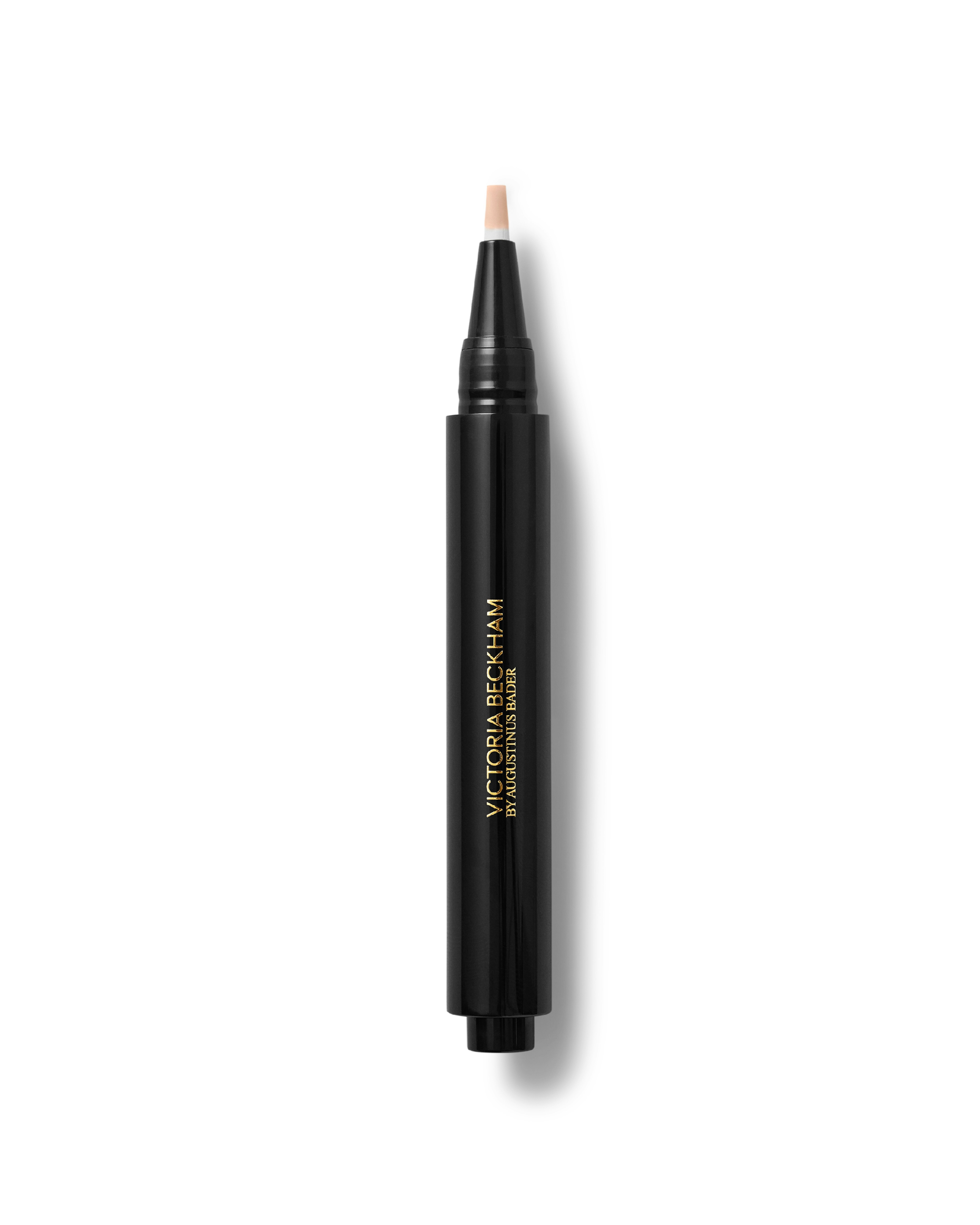 A black concealer pen is presented on a white background, there's a small bit of concealer oozing from the tip of the pen.