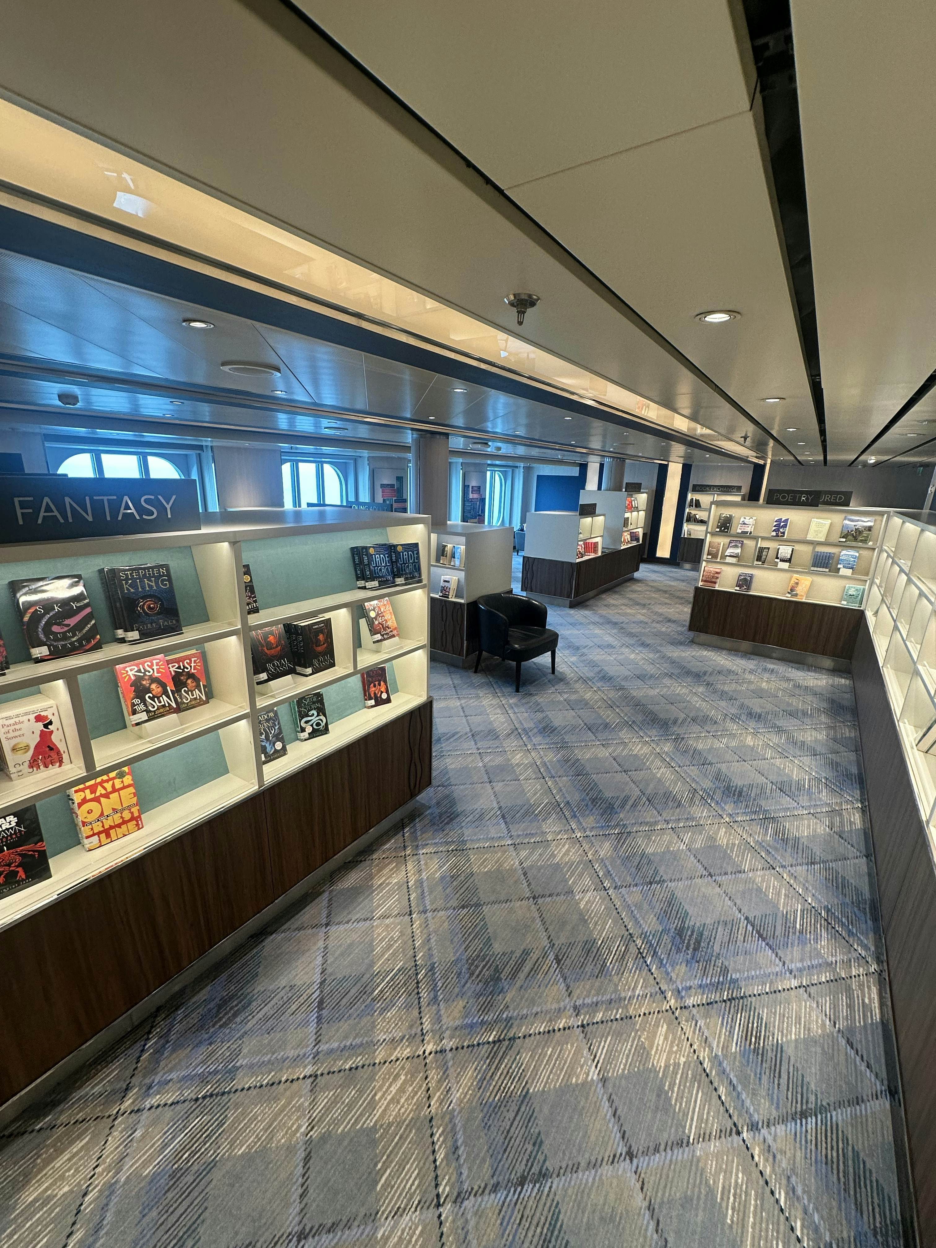 A library displays books inside a cruise ship.
