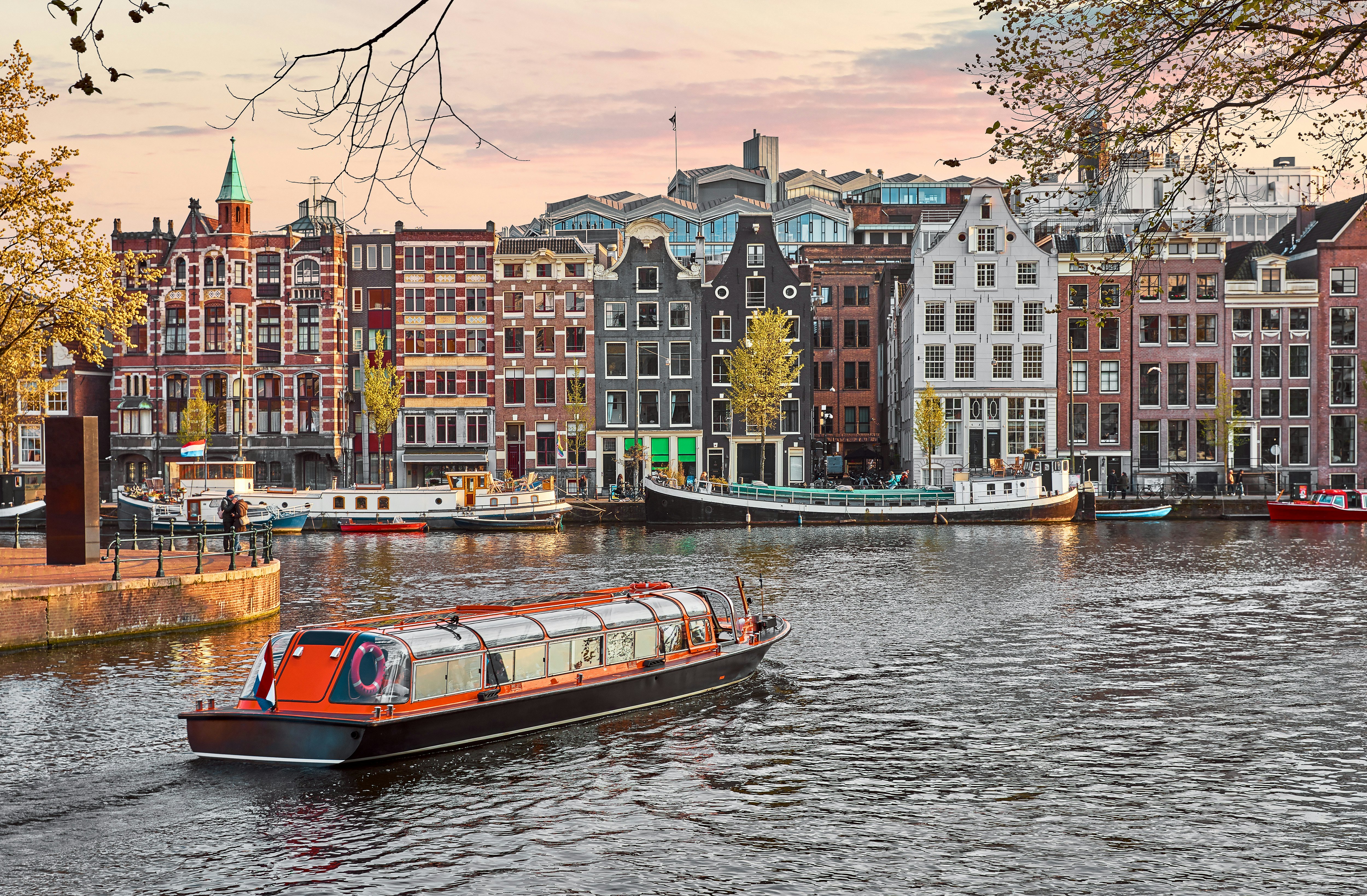 Channel in Amsterdam Netherlands houses river Amstel landmark old european city spring landscape.
