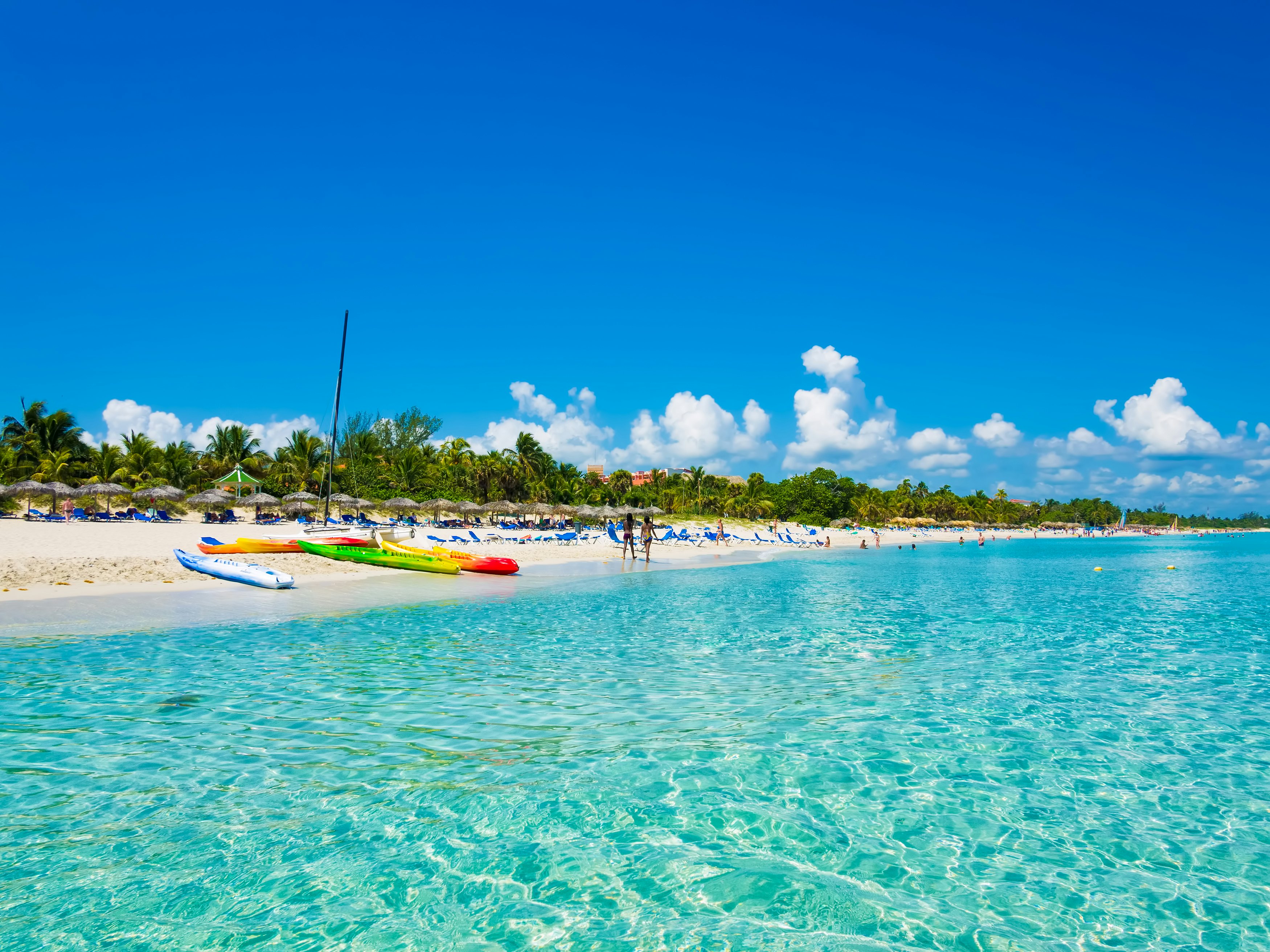 The beautiful beach of Varadero in Cuba with colorful boats and thatched umbrellas (image taken from the sea).