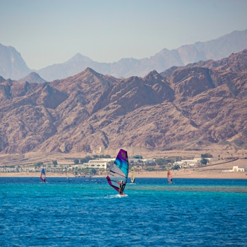 DAHAB, EGYPT - November 2020: Wind-surfer on the water in Lagoon Dahab area, Sinai, Egypt, License Type: media, Download Time: 2025-07-02T19:16:52.000Z, User: dermothegarty77, Editorial: true, purchase_order: 56530 - Guidebooks, job: Global Publishing WIP, client: Egypt-16, other: Dermot Hegarty