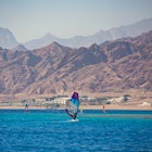 DAHAB, EGYPT - November 2020: Wind-surfer on the water in Lagoon Dahab area, Sinai, Egypt, License Type: media, Download Time: 2025-07-02T19:16:52.000Z, User: dermothegarty77, Editorial: true, purchase_order: 56530 - Guidebooks, job: Global Publishing WIP, client: Egypt-16, other: Dermot Hegarty