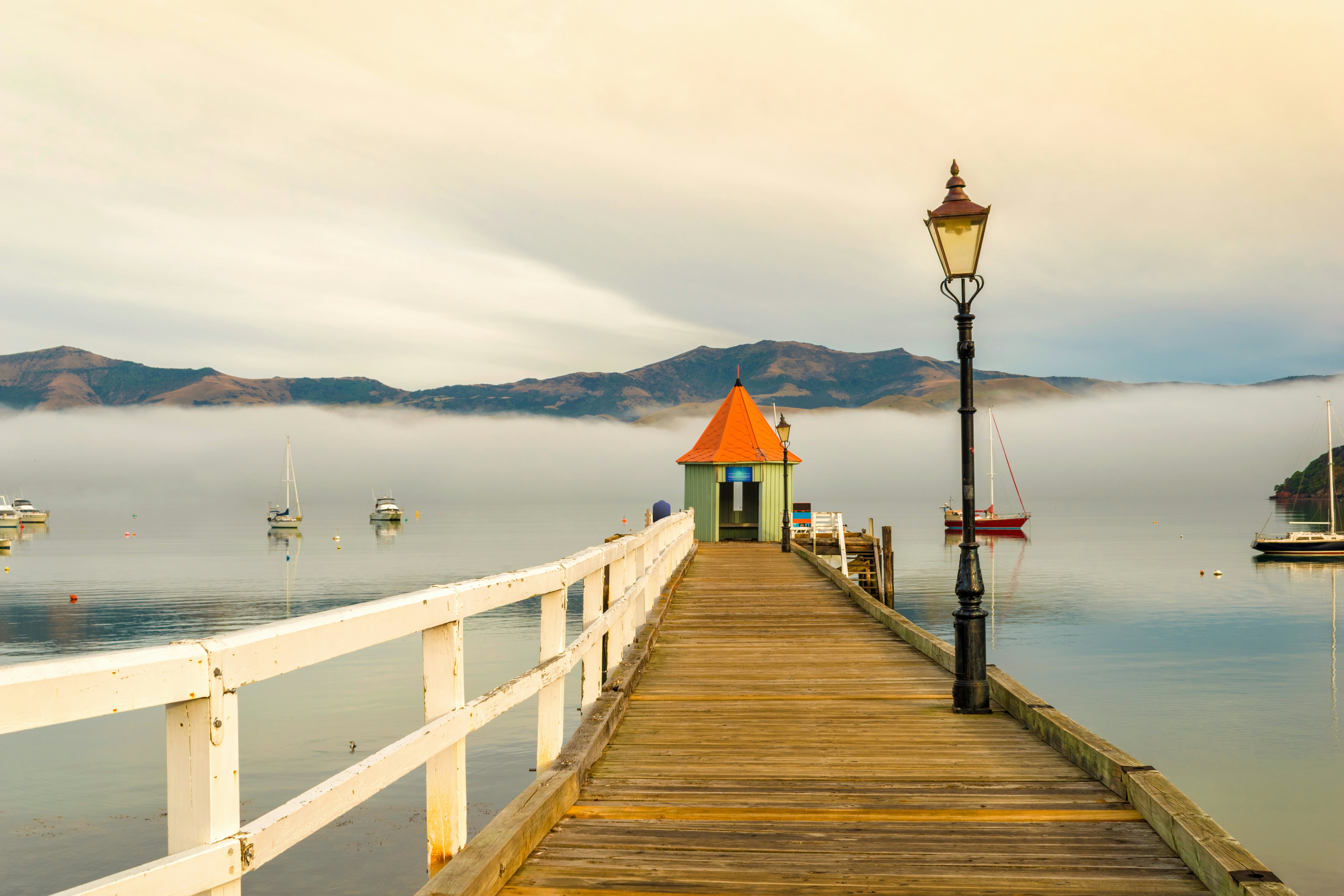Landscape Scenery of Akaroa Harbour, New Zealand on the Morning Misty Day; Small Wharf.