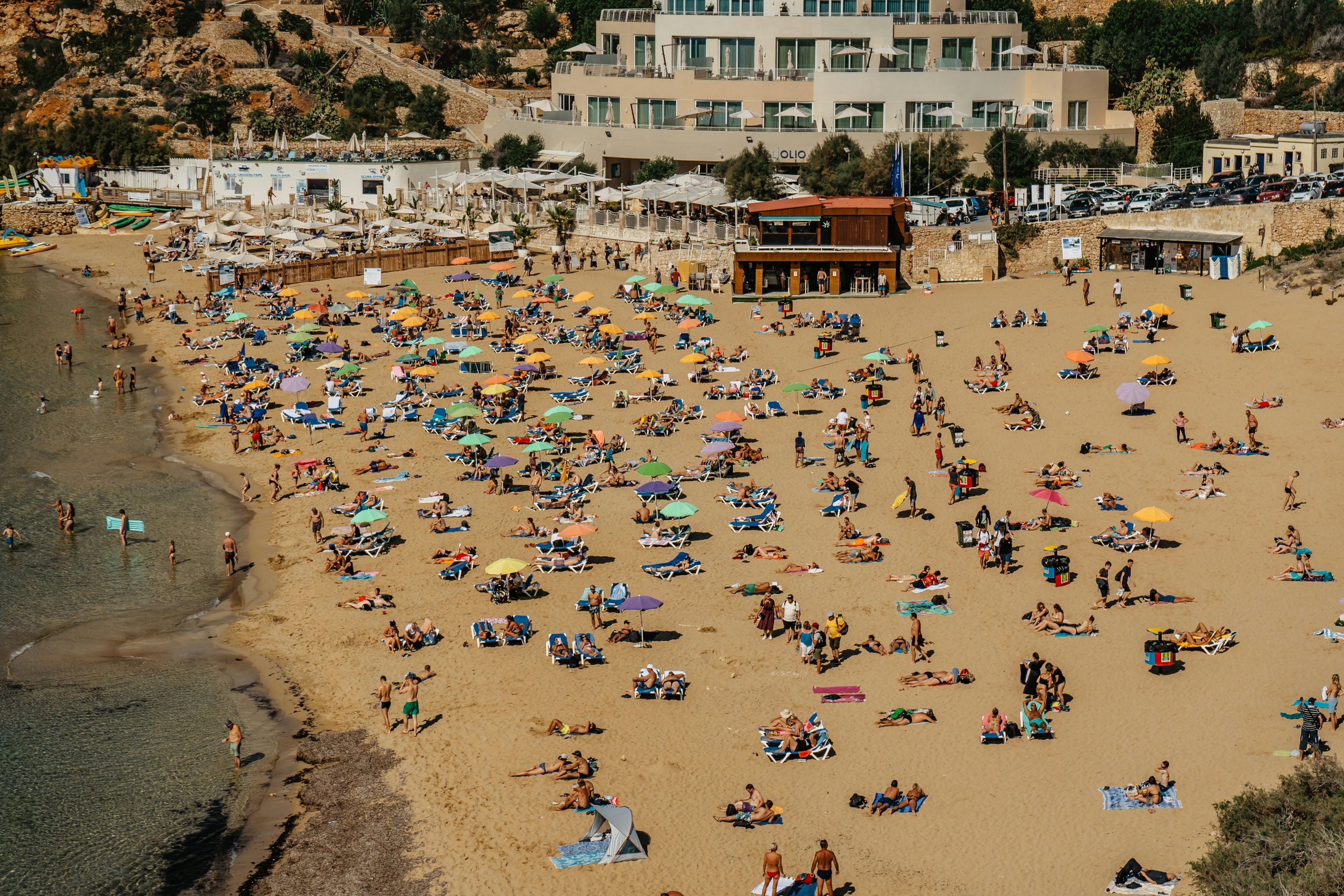 People sunbathing,swimming, doing watersports on a golden bay beach resort