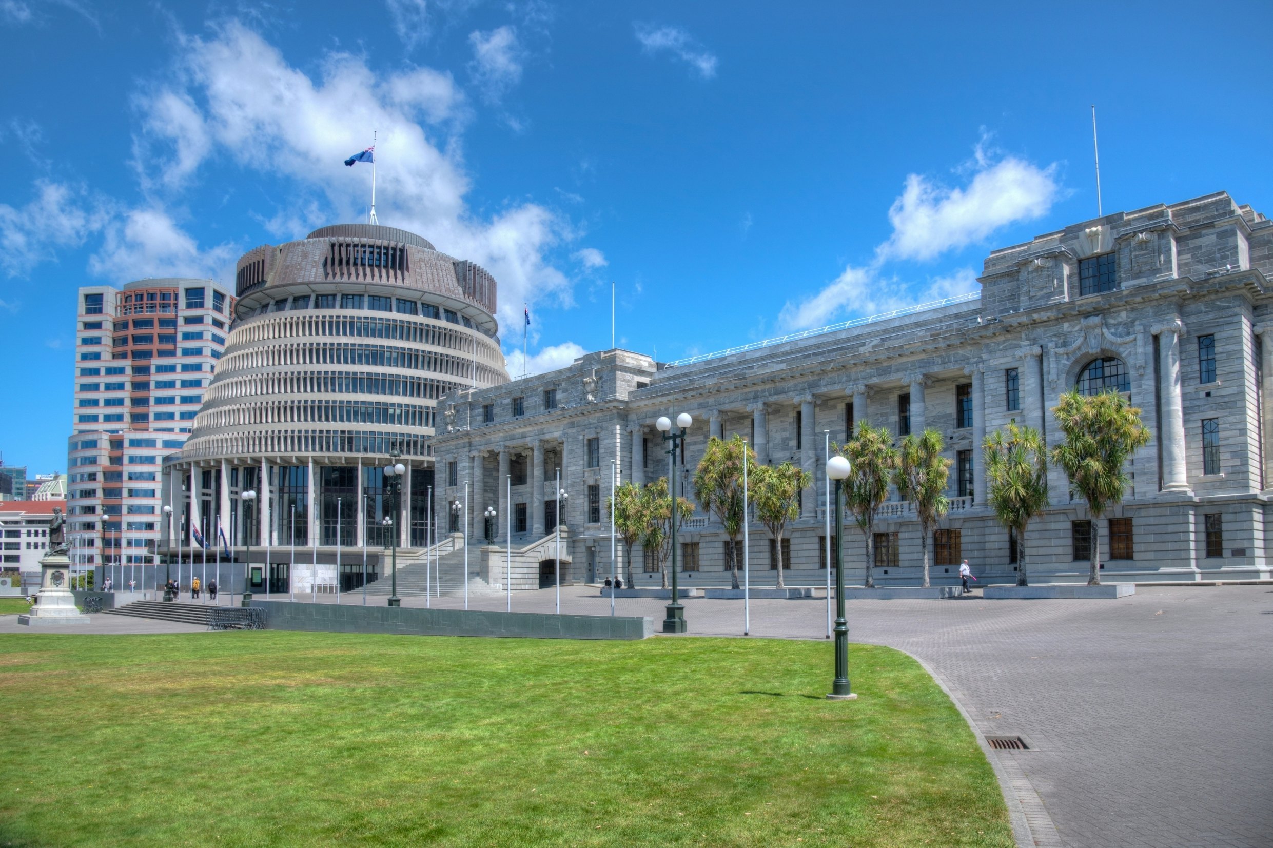 Government buildings including a round beehive-like structure with a flag flying above it.