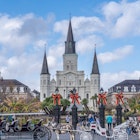 NEW ORLEANS, LA, USA - NOVEMBER 30, 2019: Cityscape photo with St. Louis Cathedral, the Cabildo, the Presbytere, mule-drawn carriages, and Christmas decorations on Jackson Square, License Type: media, Download Time: 2025-11-12T14:11:06.000Z, User: clairenaylor, Editorial: true, purchase_order: 65050 - Digital Destinations and Articles, job: online editorial, client: New Orleans Christmas, other: Claire Naylor