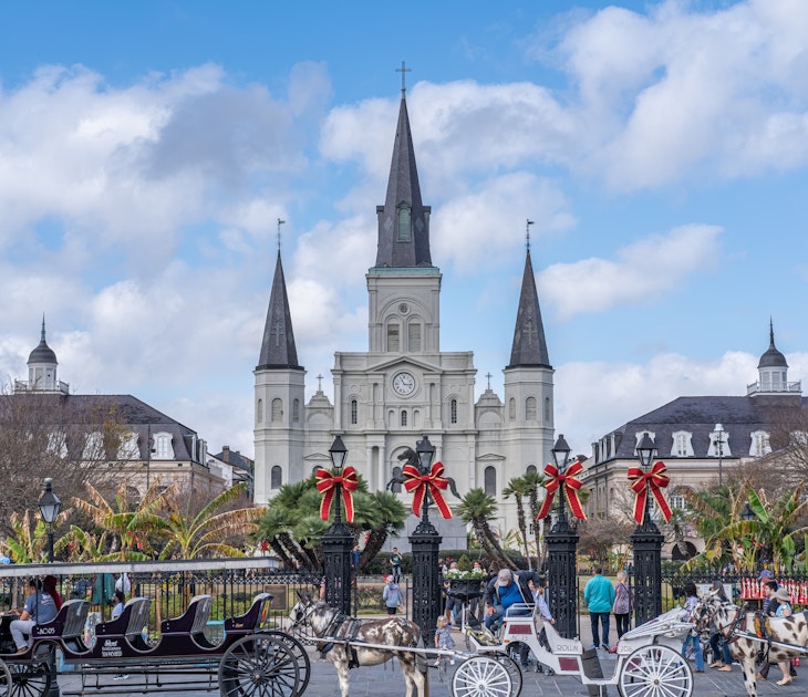 NEW ORLEANS, LA, USA - NOVEMBER 30, 2019: Cityscape photo with St. Louis Cathedral, the Cabildo, the Presbytere, mule-drawn carriages, and Christmas decorations on Jackson Square, License Type: media, Download Time: 2025-11-12T14:11:06.000Z, User: clairenaylor, Editorial: true, purchase_order: 65050 - Digital Destinations and Articles, job: online editorial, client: New Orleans Christmas, other: Claire Naylor