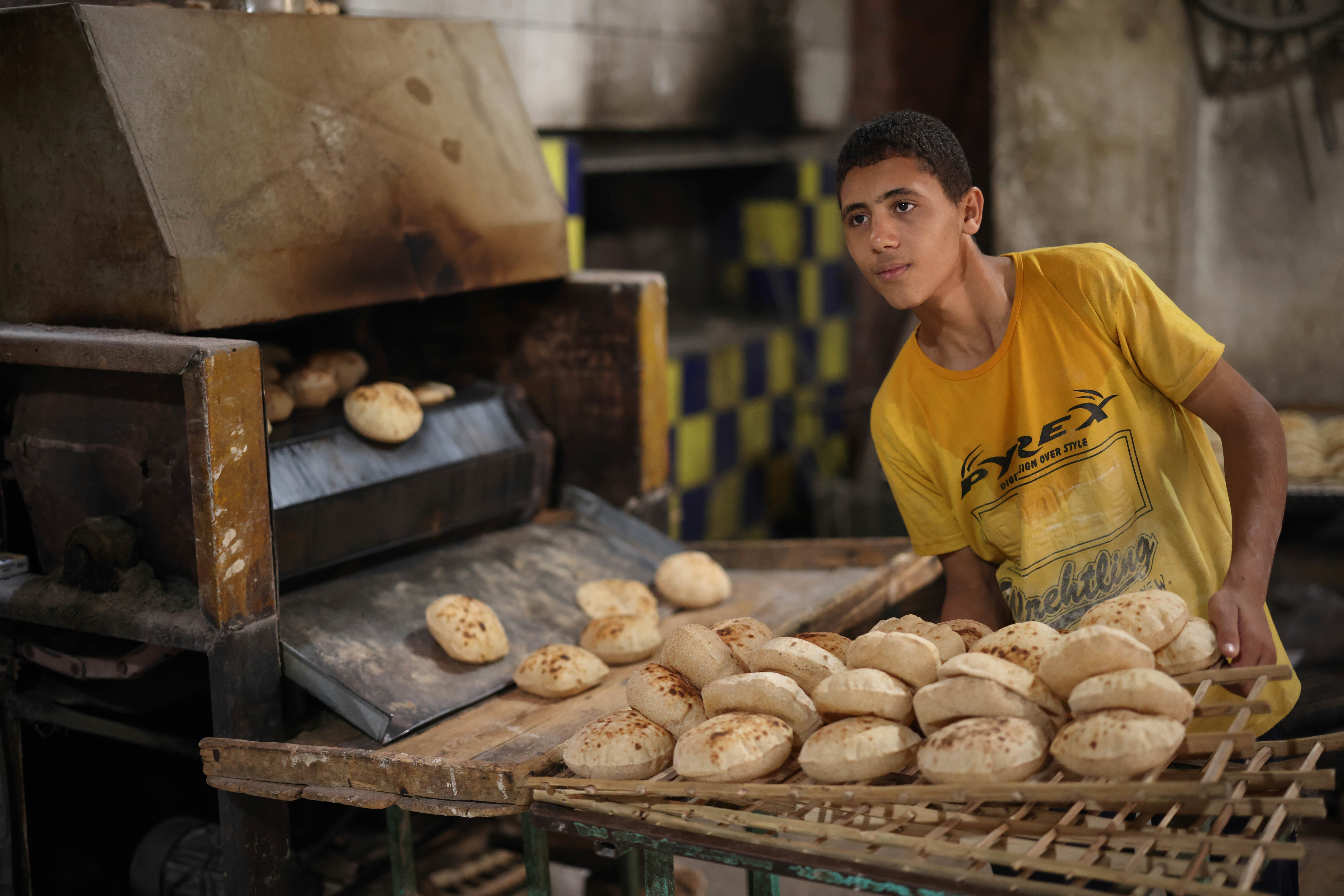 CAIRO, EGYPT - NOVEMBER 30, 2021: A young man works in a traditional bakery in Cairo, License Type: media, Download Time: 2025-11-10T11:23:43.000Z, User: joebindloss38, Editorial: true, purchase_order: 65050 - Digital Destinations and Articles, job: Online Editorial, client:  The best things to eat and drink in Egypt, other: Joe Bindloss