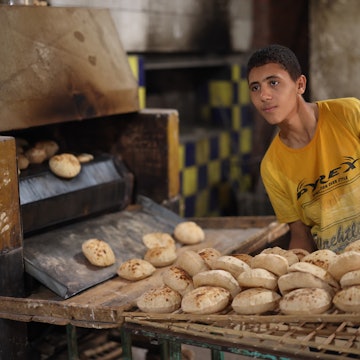 CAIRO, EGYPT - NOVEMBER 30, 2021: A young man works in a traditional bakery in Cairo, License Type: media, Download Time: 2025-11-10T11:23:43.000Z, User: joebindloss38, Editorial: true, purchase_order: 65050 - Digital Destinations and Articles, job: Online Editorial, client: The best things to eat and drink in Egypt, other: Joe Bindloss