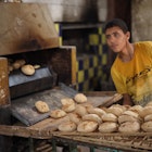 CAIRO, EGYPT - NOVEMBER 30, 2021: A young man works in a traditional bakery in Cairo, License Type: media, Download Time: 2025-11-10T11:23:43.000Z, User: joebindloss38, Editorial: true, purchase_order: 65050 - Digital Destinations and Articles, job: Online Editorial, client: The best things to eat and drink in Egypt, other: Joe Bindloss