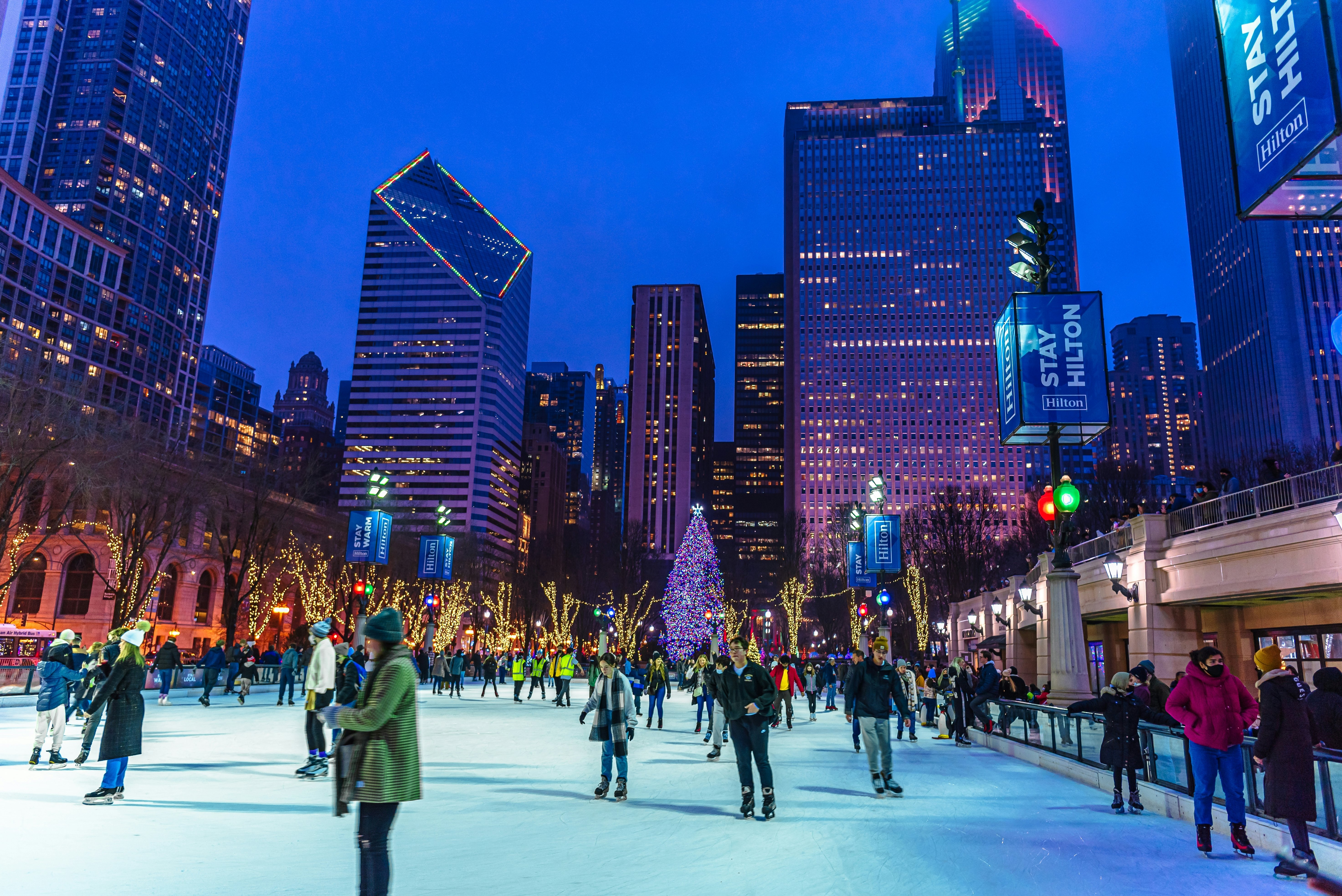 People are enjoying ice skating during beautiful winter night